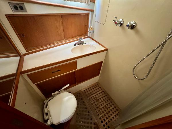 1979 Grand Banks Classic yacht bathroom with sink, shower, and toilet.