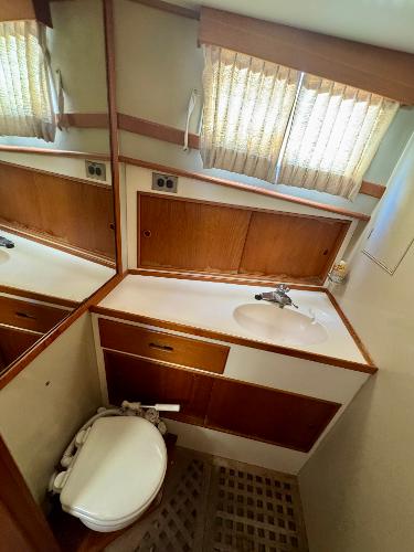 1979 Grand Banks Classic yacht bathroom with wood accents and compact design.