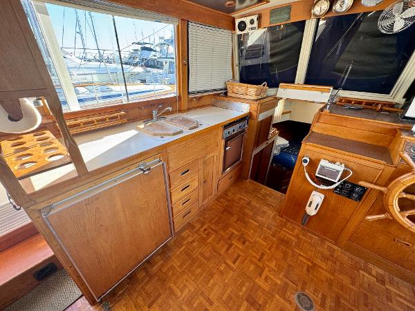 1979 Grand Banks Classic yacht interior with wooden cabinetry and nautical instruments.