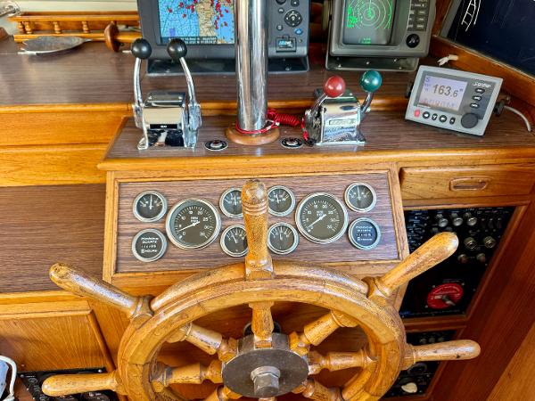1979 Grand Banks Classic helm with wooden wheel and navigation instruments.