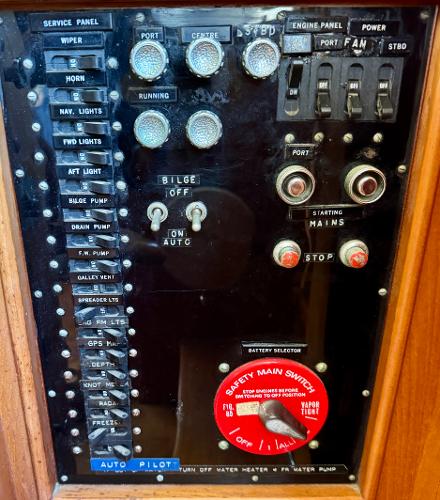 Control panel of a 1979 Grand Banks Classic boat with various switches and indicators.