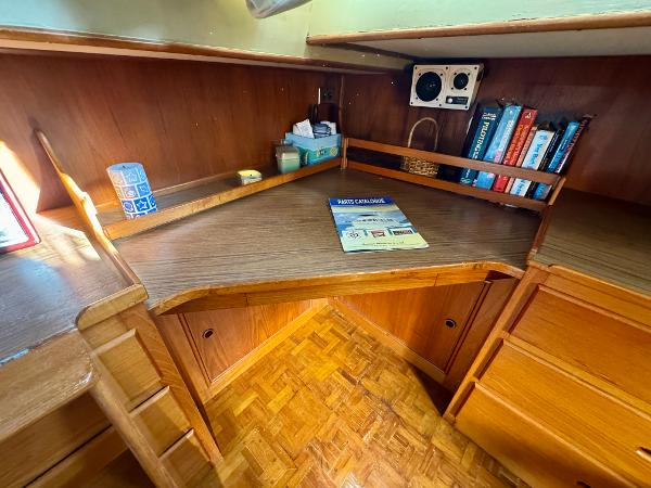 1979 Grand Banks Classic boat interior with wooden desk and bookshelves.