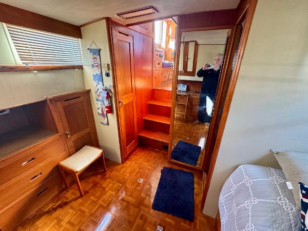 Interior of 1979 Grand Banks Classic yacht with wooden furnishings and cozy decor.