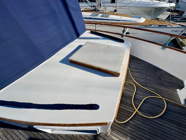 1979 Grand Banks Classic yacht deck with blue cover and wooden accents.