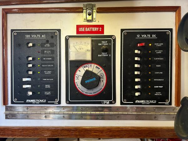 Electrical control panel on a 1975 Salar 40 boat, featuring AC and DC switches.