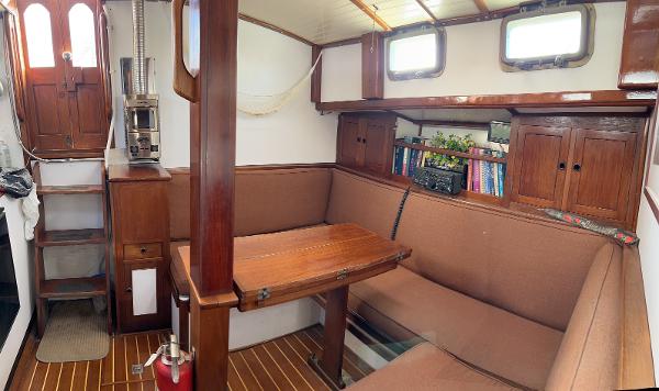 Cozy 1975 Salar 40 sailboat interior with wooden furnishings and built-in seating.