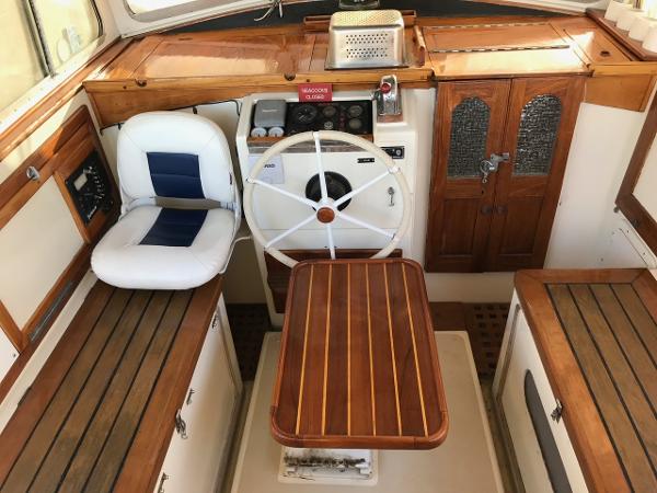 Interior of a 1975 Salar 40 boat with wooden accents and steering wheel.