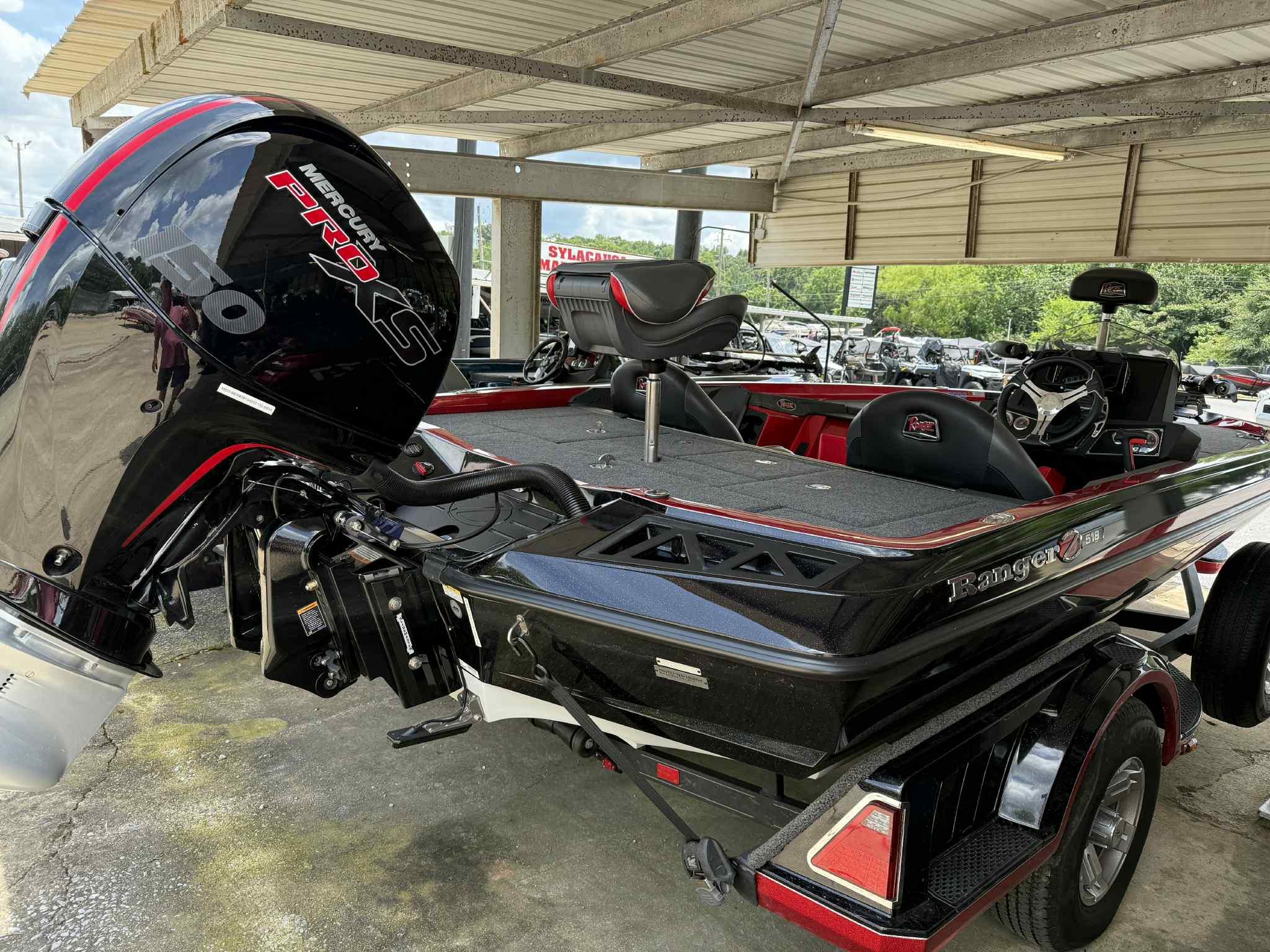 2022 Ranger Z518 boat with Mercury Pro XS engine, parked under a metal canopy.