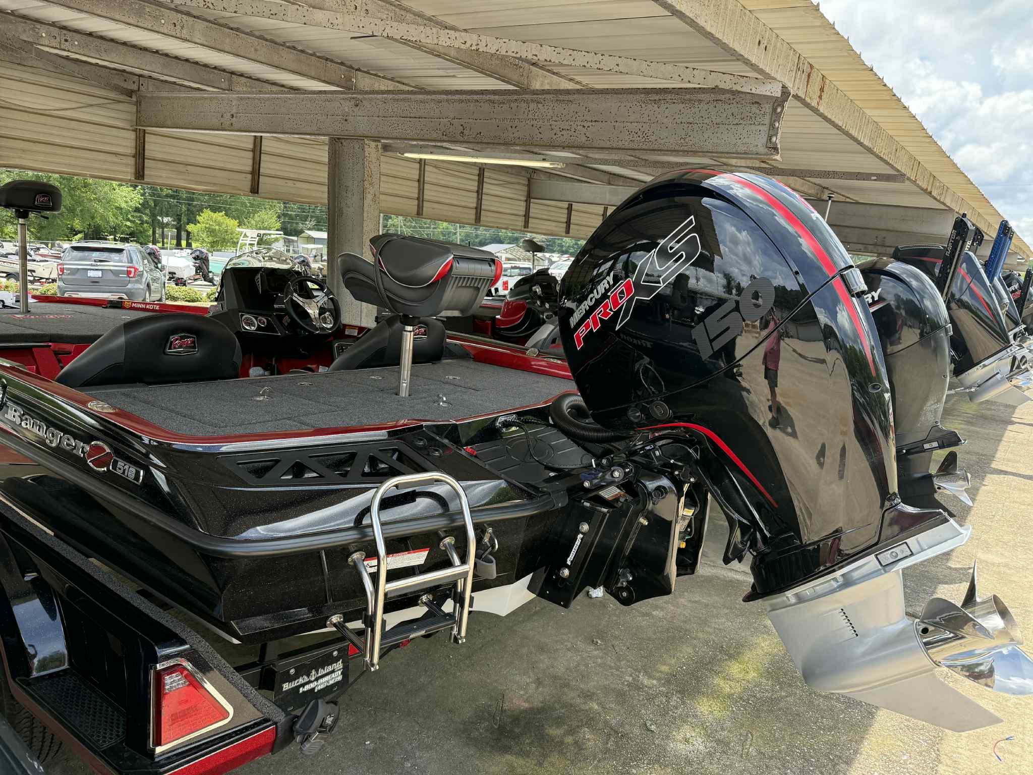 2022 Ranger Z518 boat with Mercury Pro XS engine, parked under a shelter.