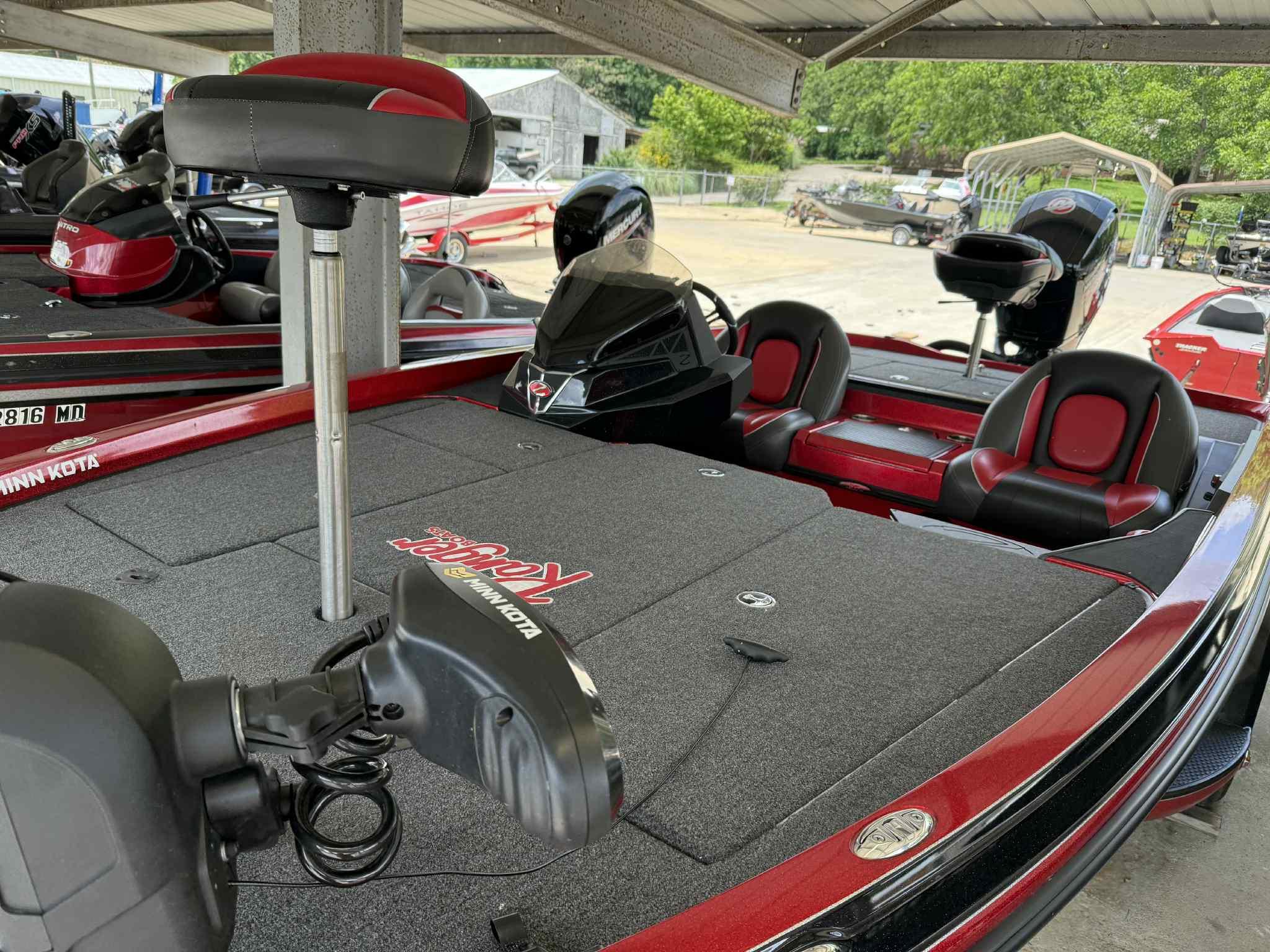 2022 Ranger Z518 boat with Minn Kota trolling motor and red-black seating under a shelter.
