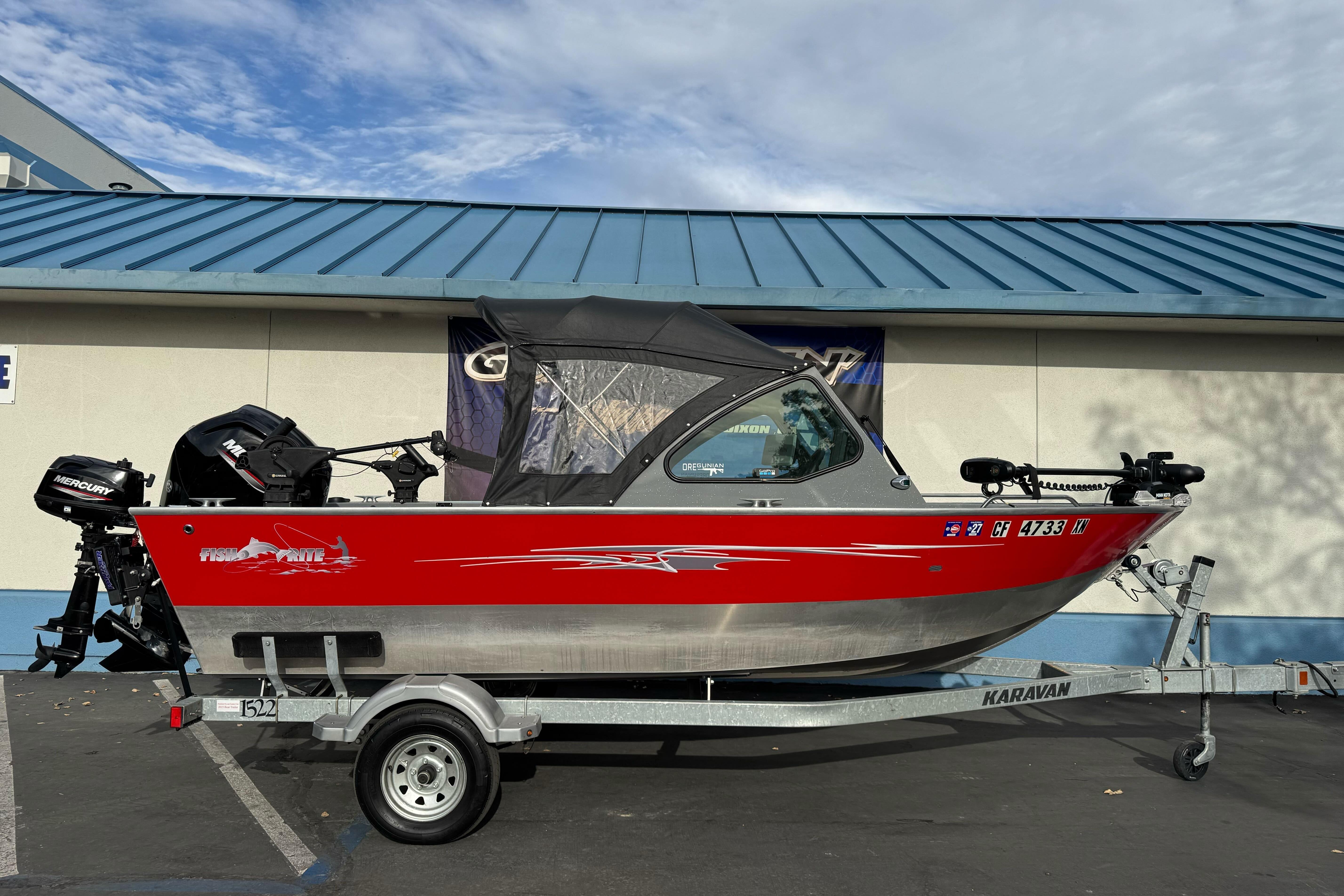 2018 Fish Rite 16.5 Stalker boat on trailer, red and silver design, parked outdoors.