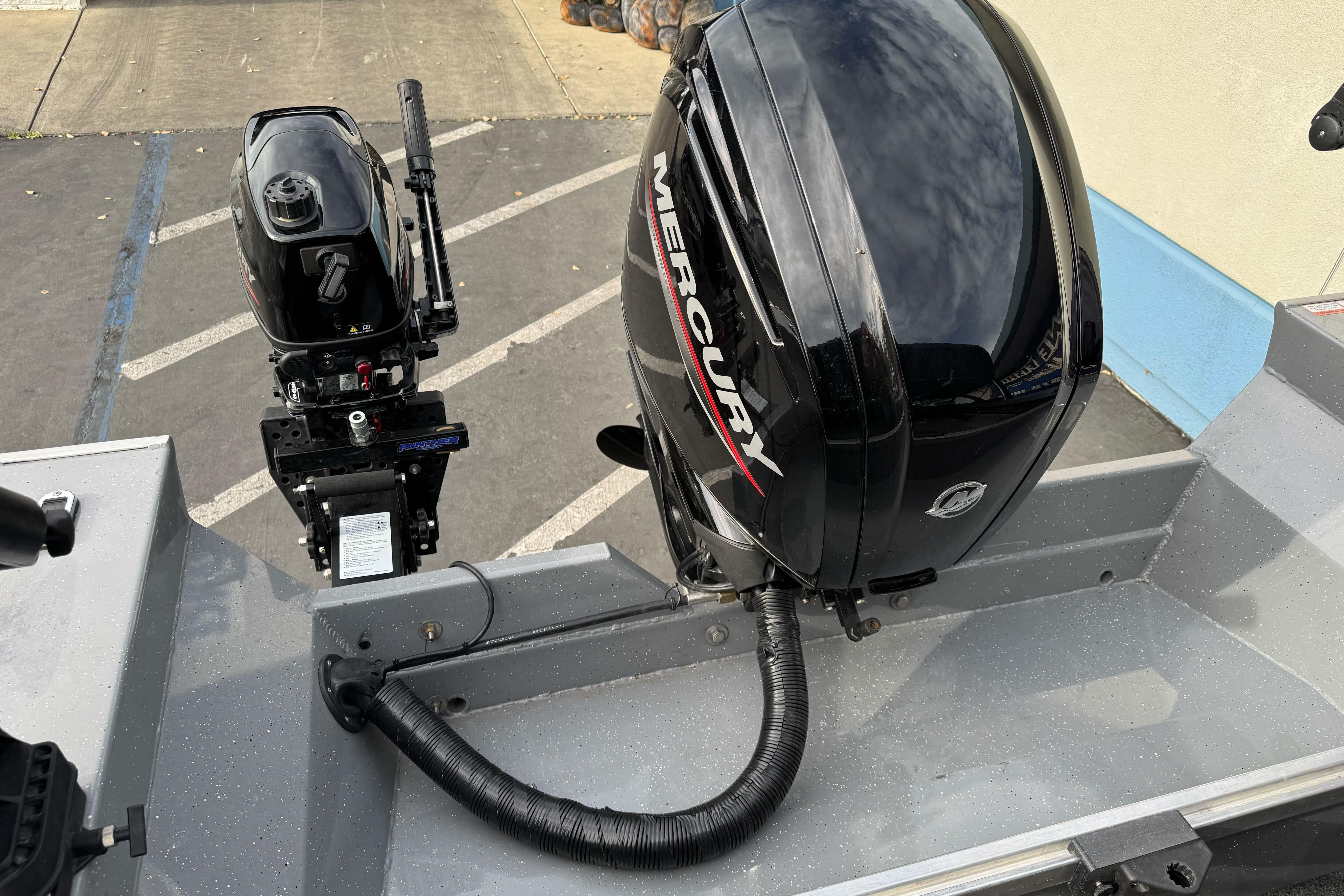2018 Fish Rite 16.5 Stalker boat with Mercury outboard motor in parking lot.