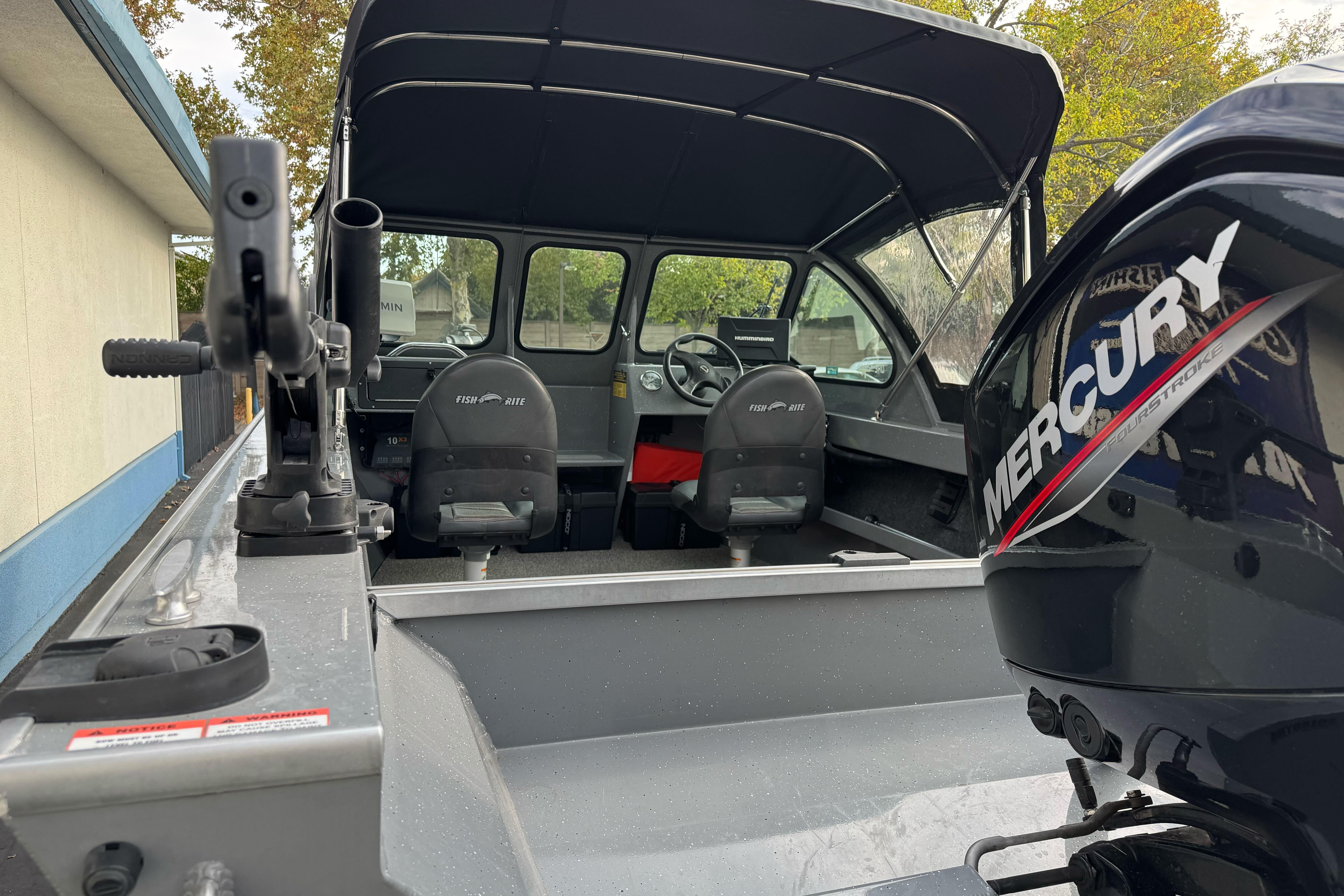 2018 Fish Rite 16.5 Stalker boat interior with Mercury engine, featuring seating and controls.