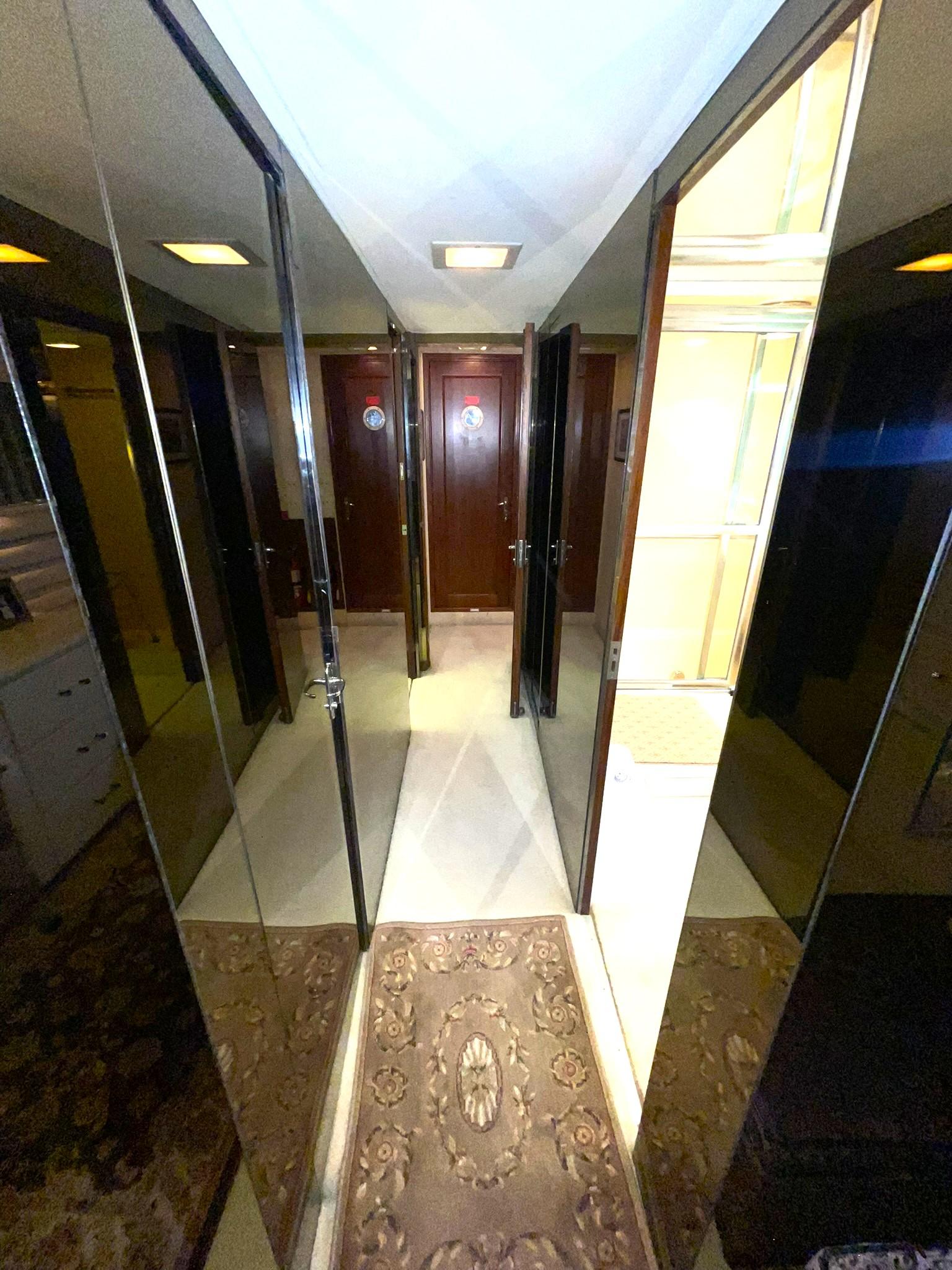 Hatteras-80 Cockpit Motor Yacht 1989-GENTLE BEN VA-US-COMPANIONWAY TO MASTER STATEROOM LOOKING FORWARD TO ENGINE ROOM DOOR-9784968 | Thumbnail
