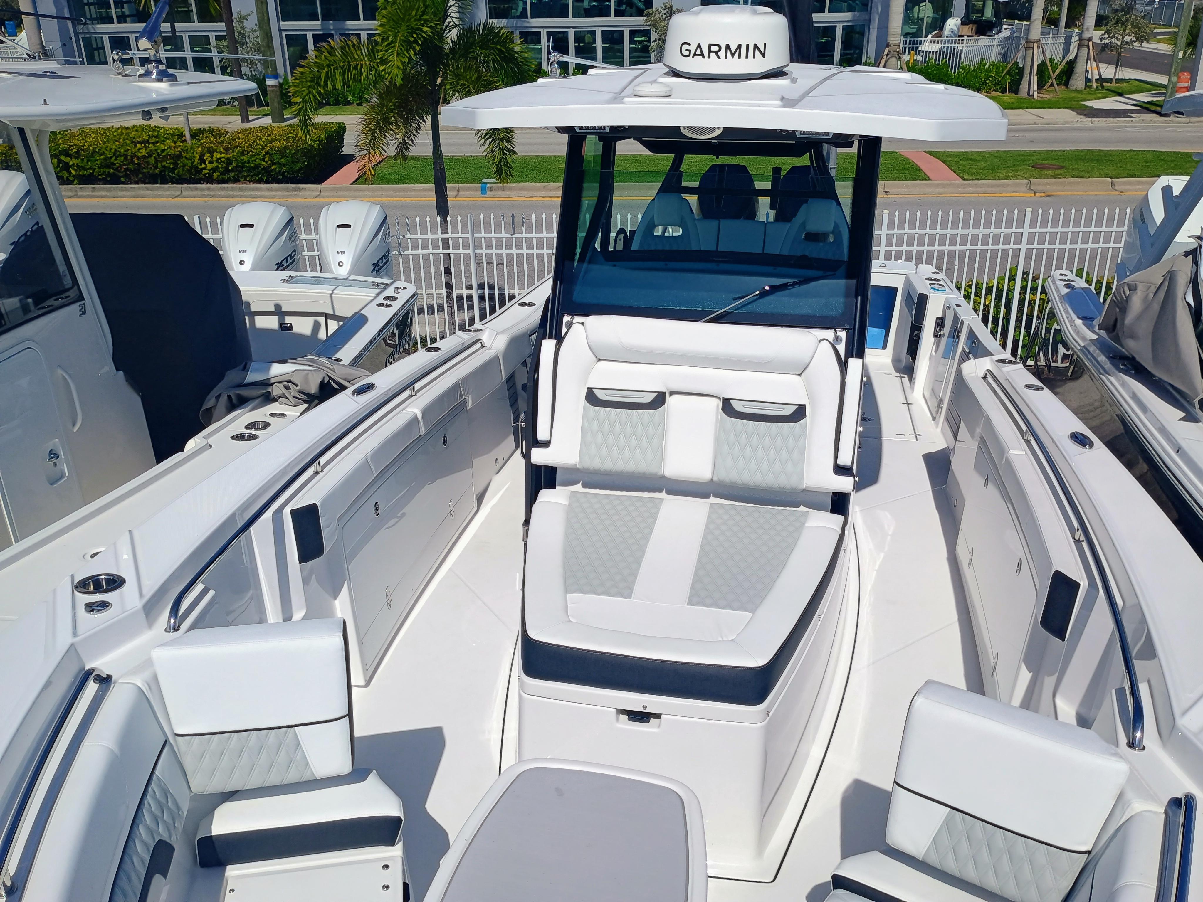 Picture of 332-299 Blackfin 35.83 ft' 332 CC 2025 Blackfin 332 CC boat interior with seating and Garmin equipment, docked outdoors. 