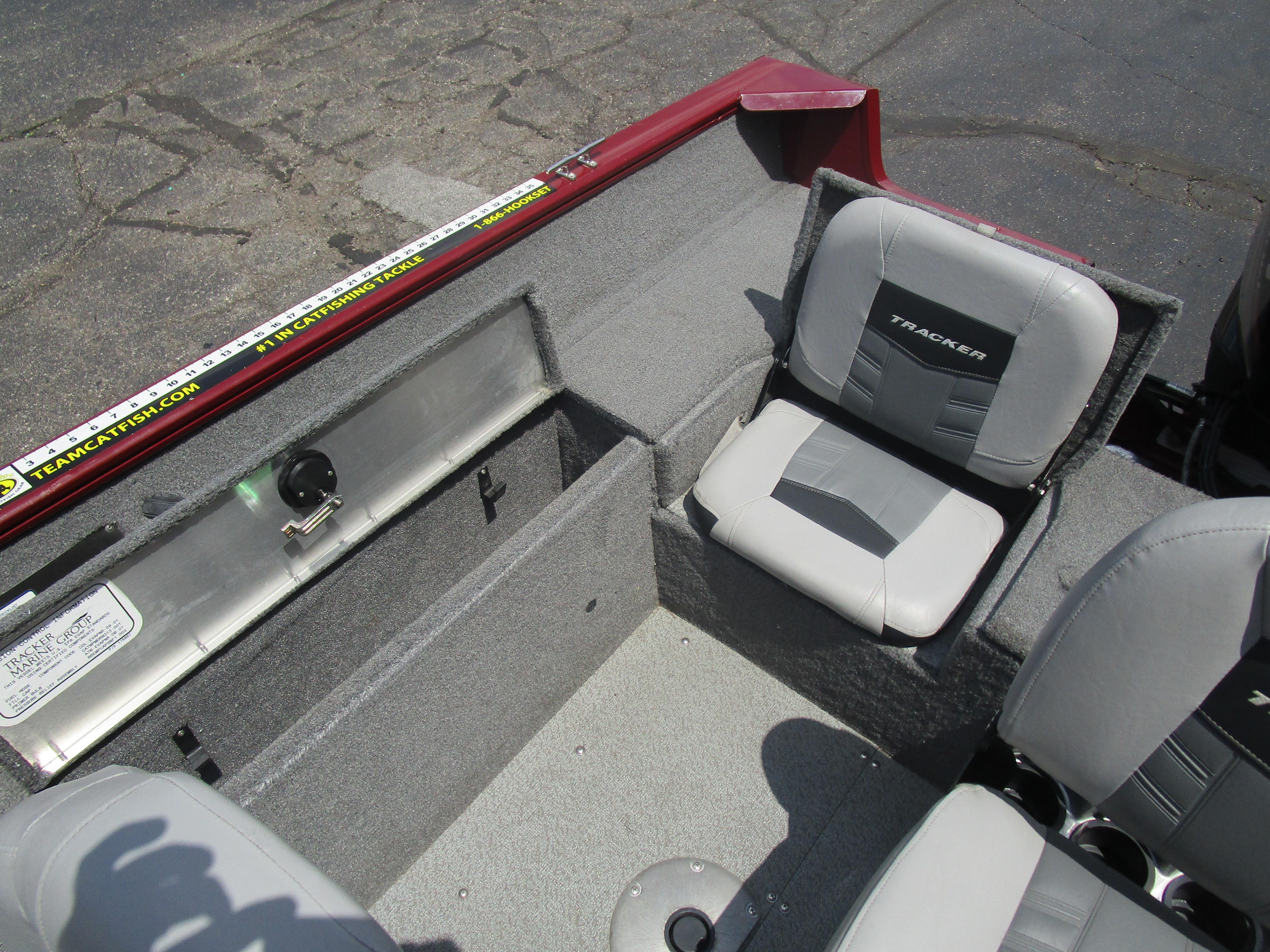 2017 Tracker PGV175 COMBO boat interior with gray seating and storage compartments.
