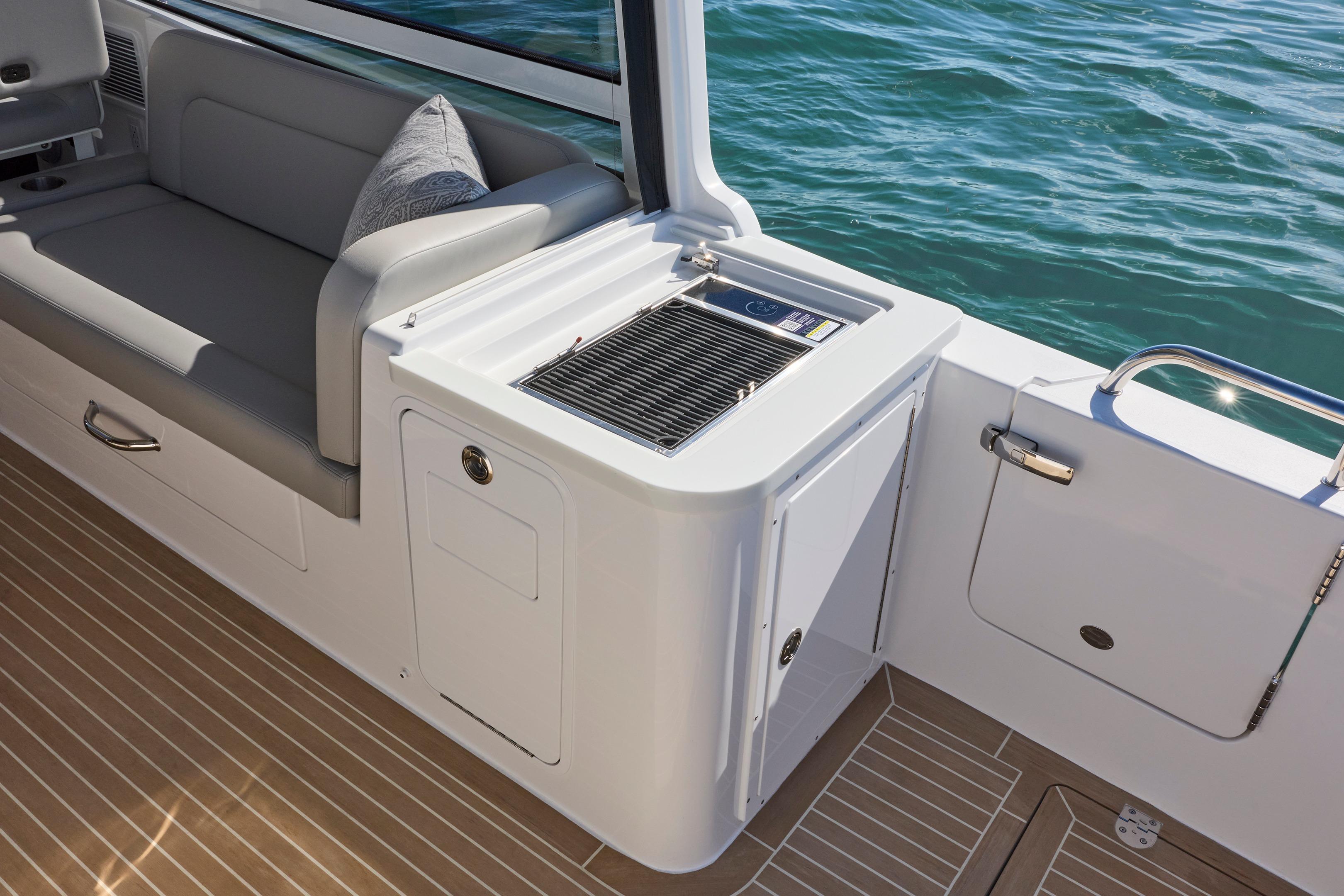 2026 MJM 38x boat interior with seating and grill by the water.