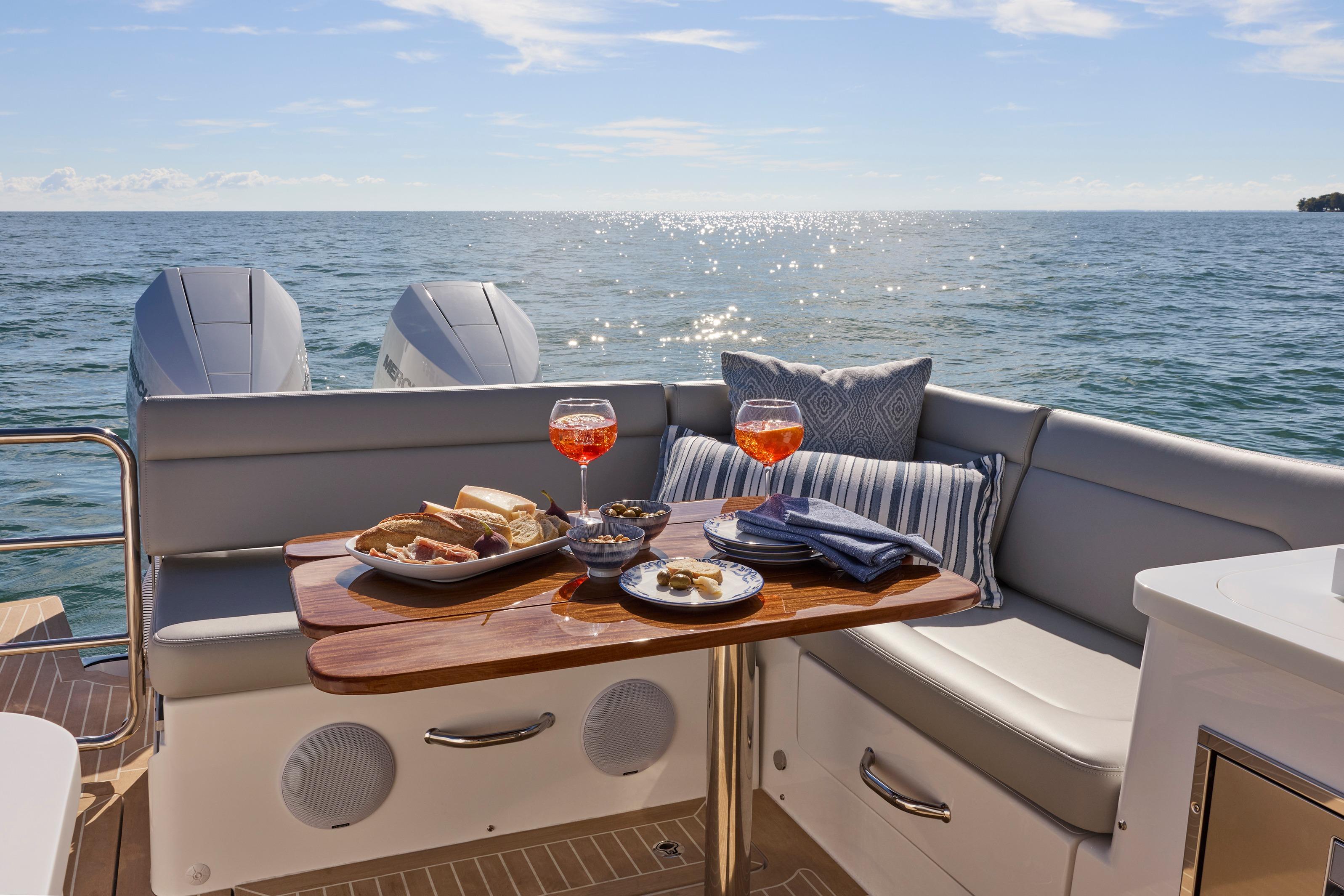 Luxurious MJM 38x yacht interior with dining setup, ocean view, and twin engines, 2026 model.