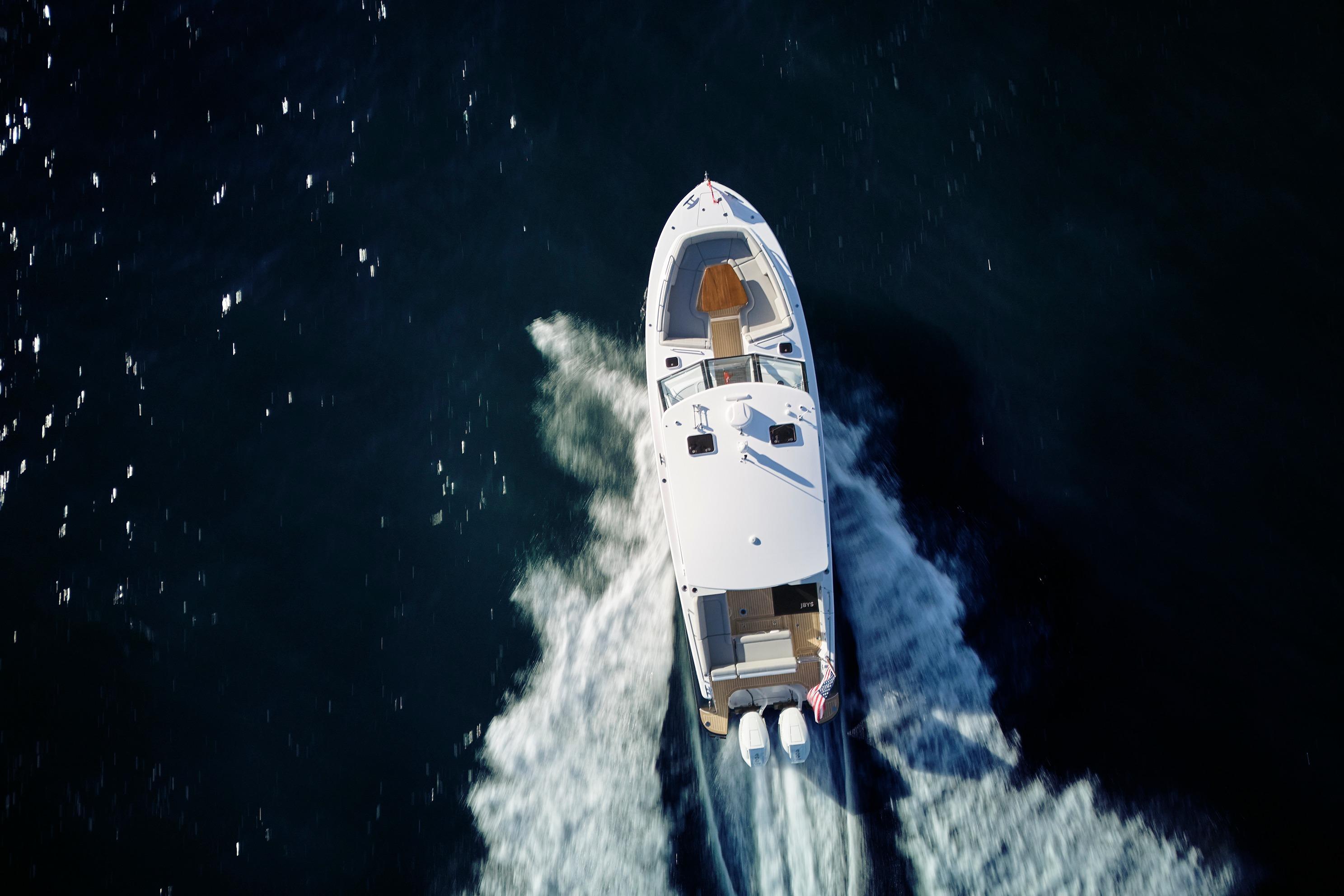 Aerial view of 2026 MJM 38x boat cruising on open water.