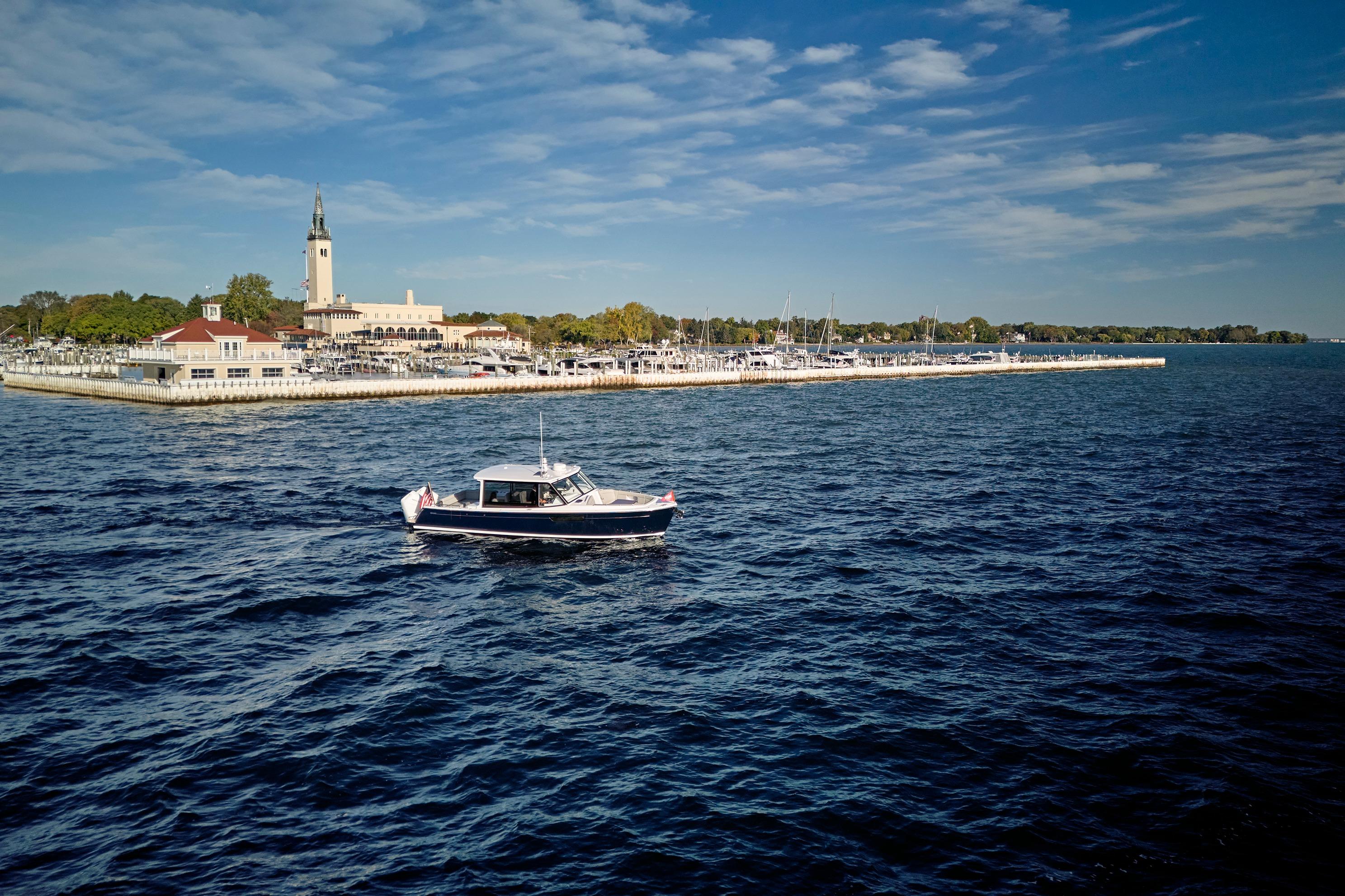 MJM 38x boat cruising near marina, clear sky, 2026 model.