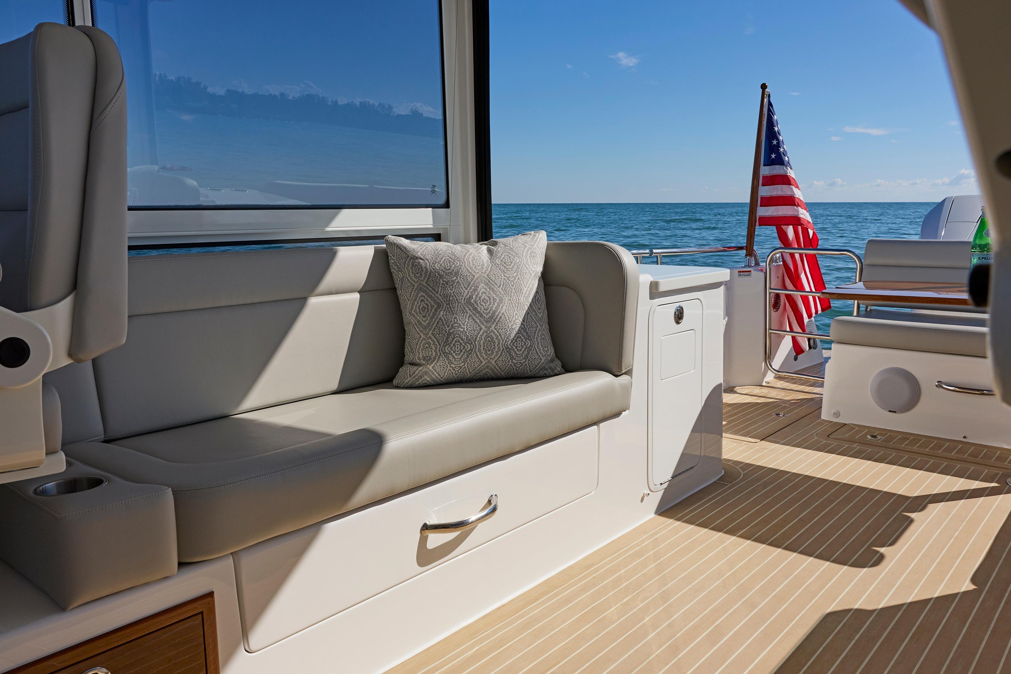 Luxurious 2026 MJM 38x yacht interior with ocean view and American flag.