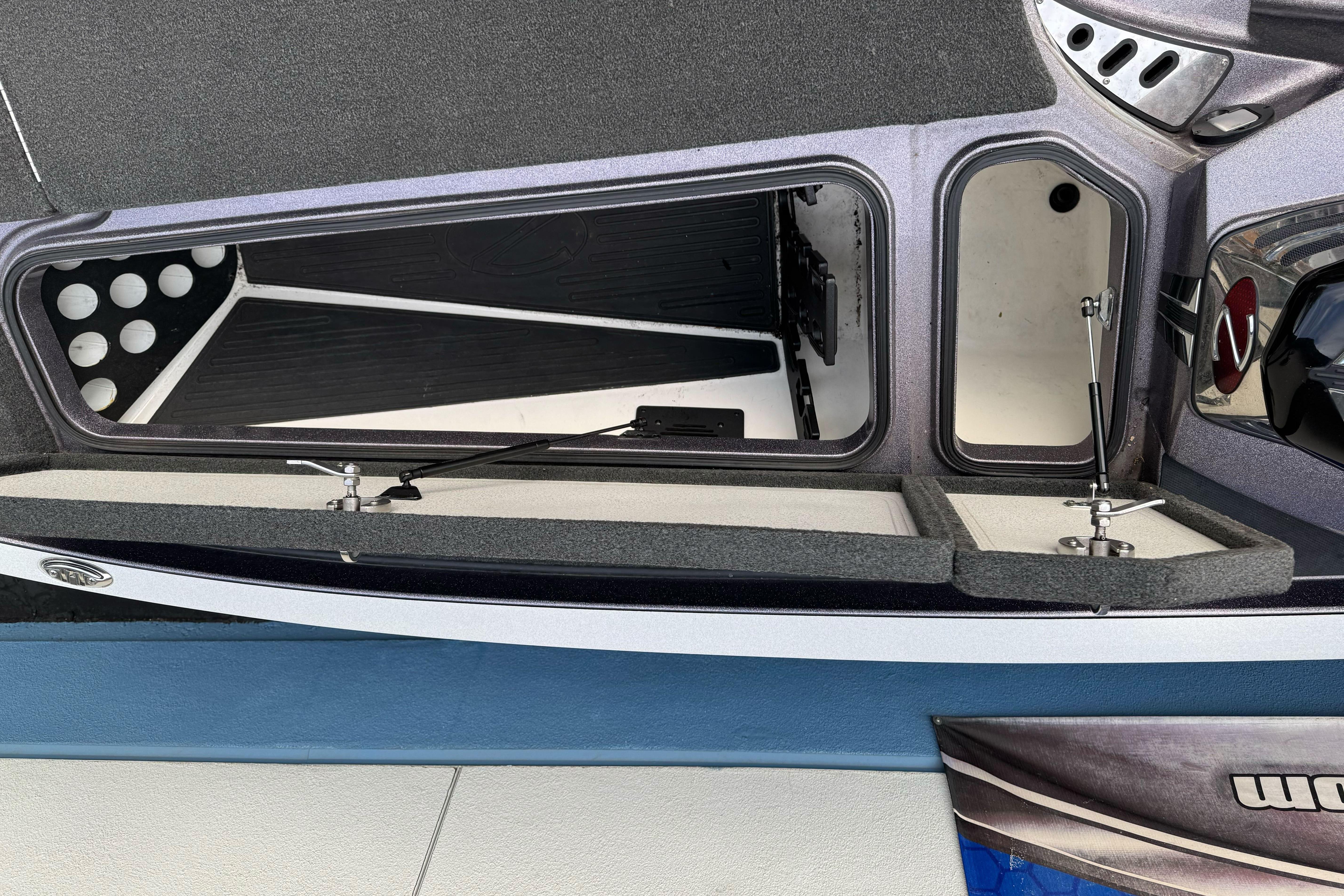 2016 Ranger Z521 Comanche boat storage compartments open, showcasing interior design.