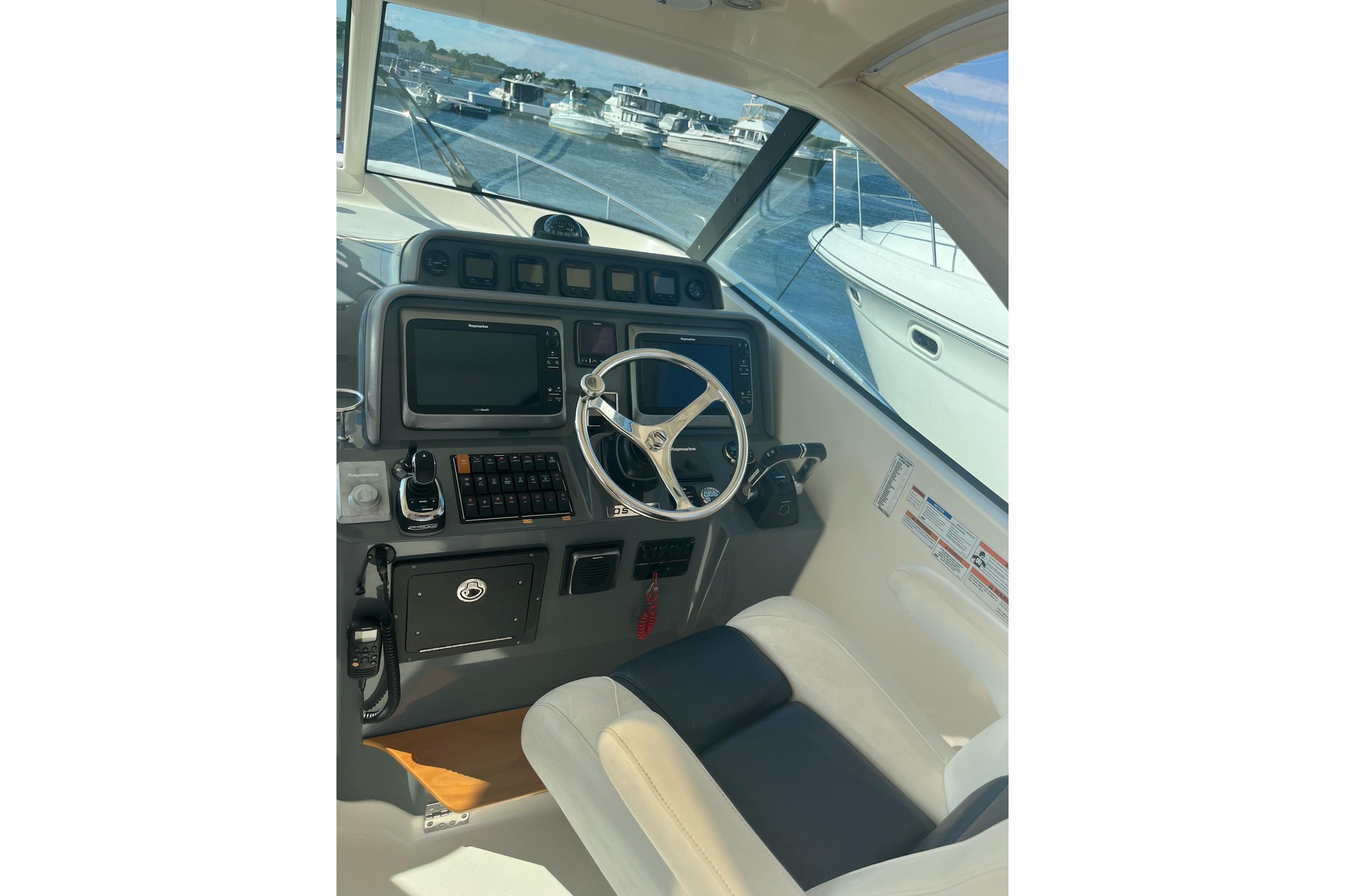 2009 Pursuit OS 375 Offshore helm with steering wheel and navigation controls.