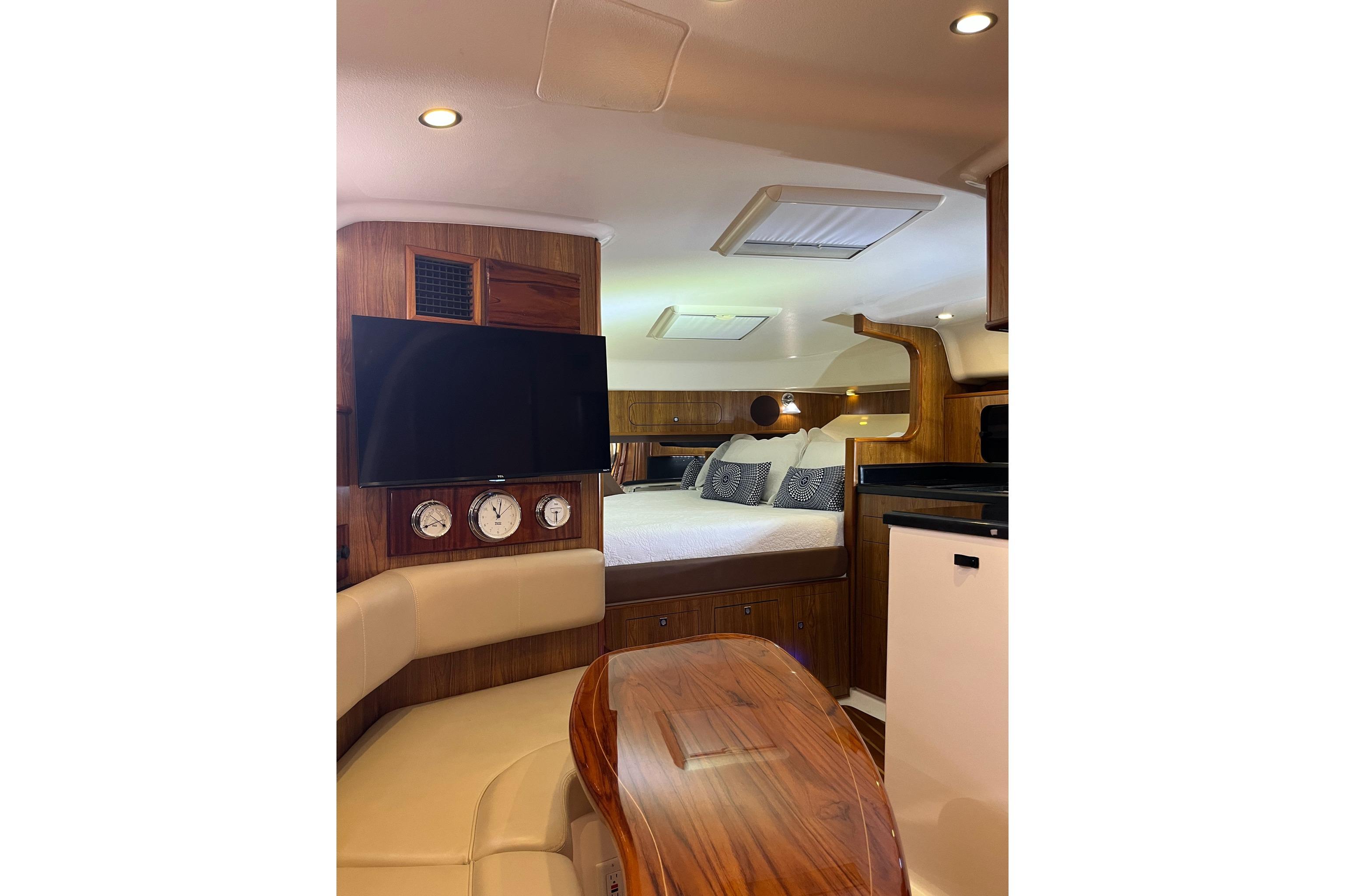 Luxurious interior of 2009 Pursuit OS 375 Offshore yacht with cozy seating and modern amenities.