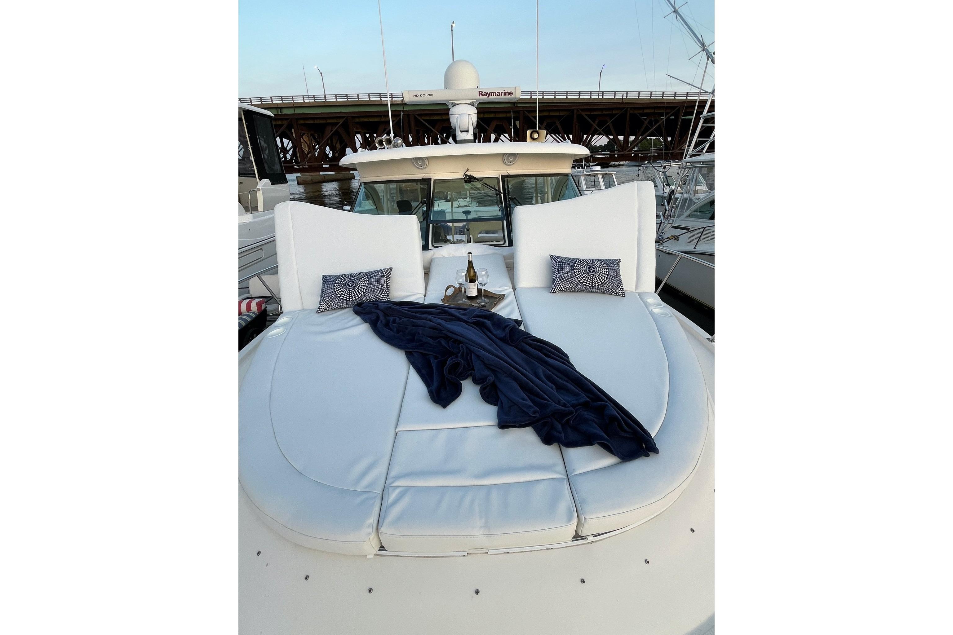 2009 Pursuit OS 375 Offshore yacht with luxurious deck seating and elegant decor.