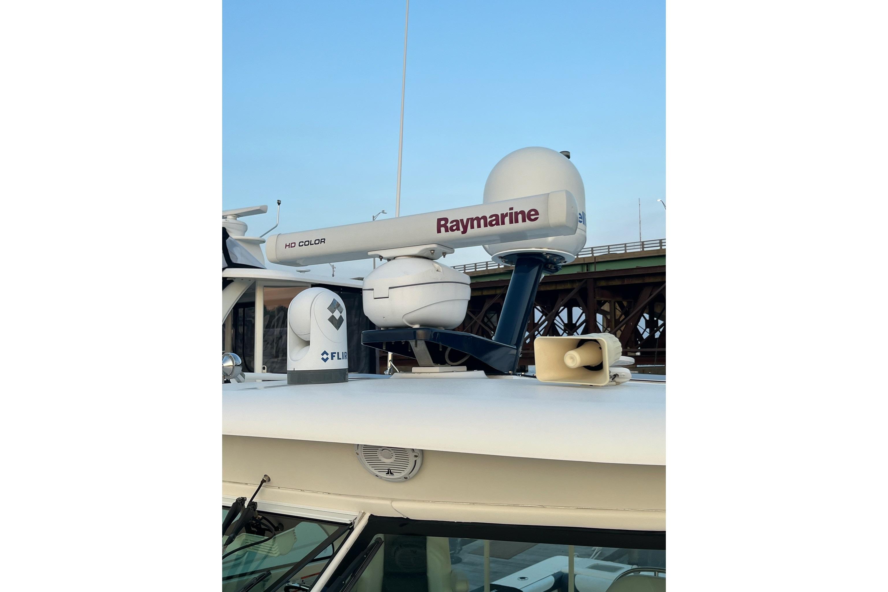 2009 Pursuit OS 375 Offshore boat with Raymarine radar and FLIR camera on deck.