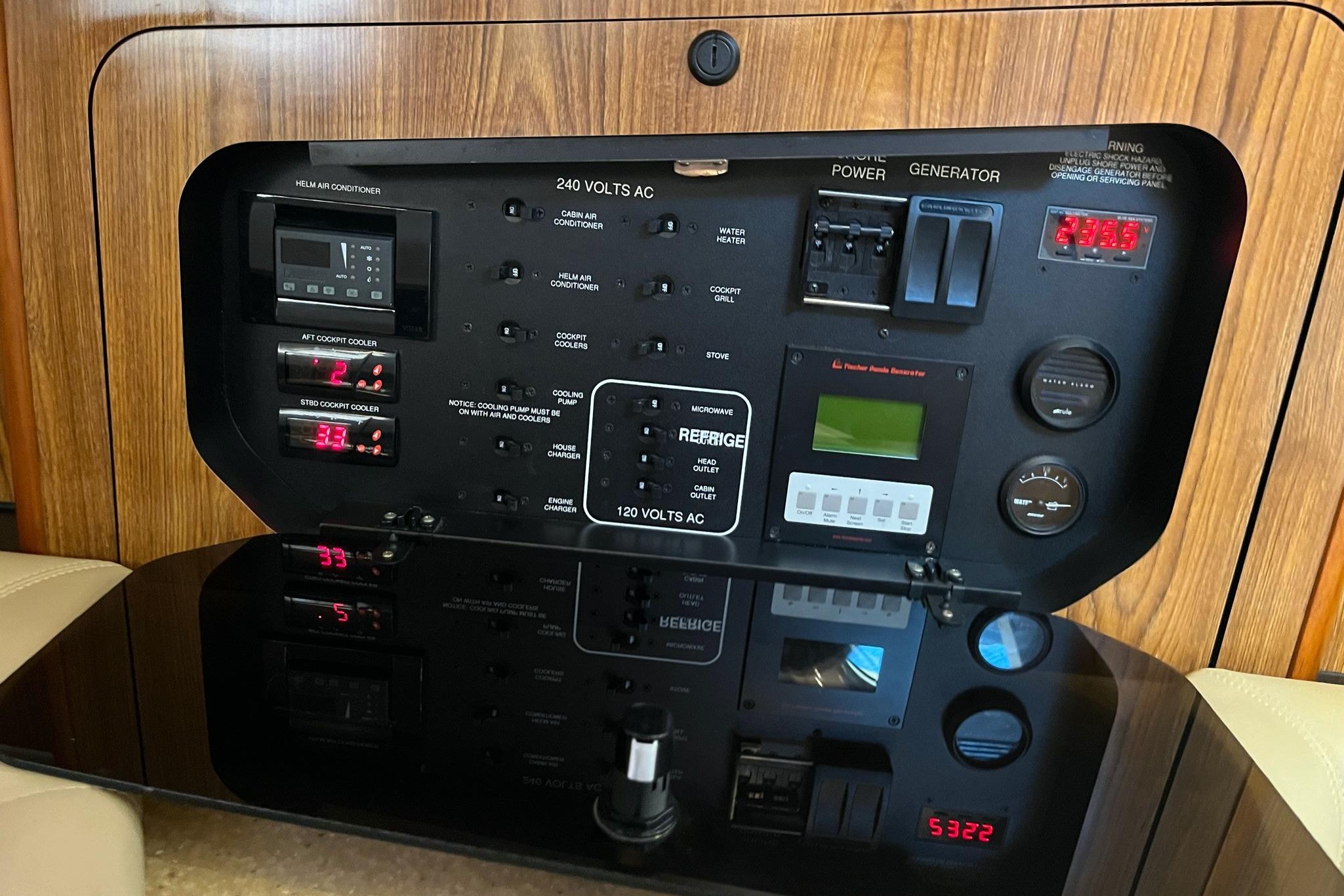 Control panel of a 2009 Pursuit OS 375 Offshore boat, featuring various switches and gauges.