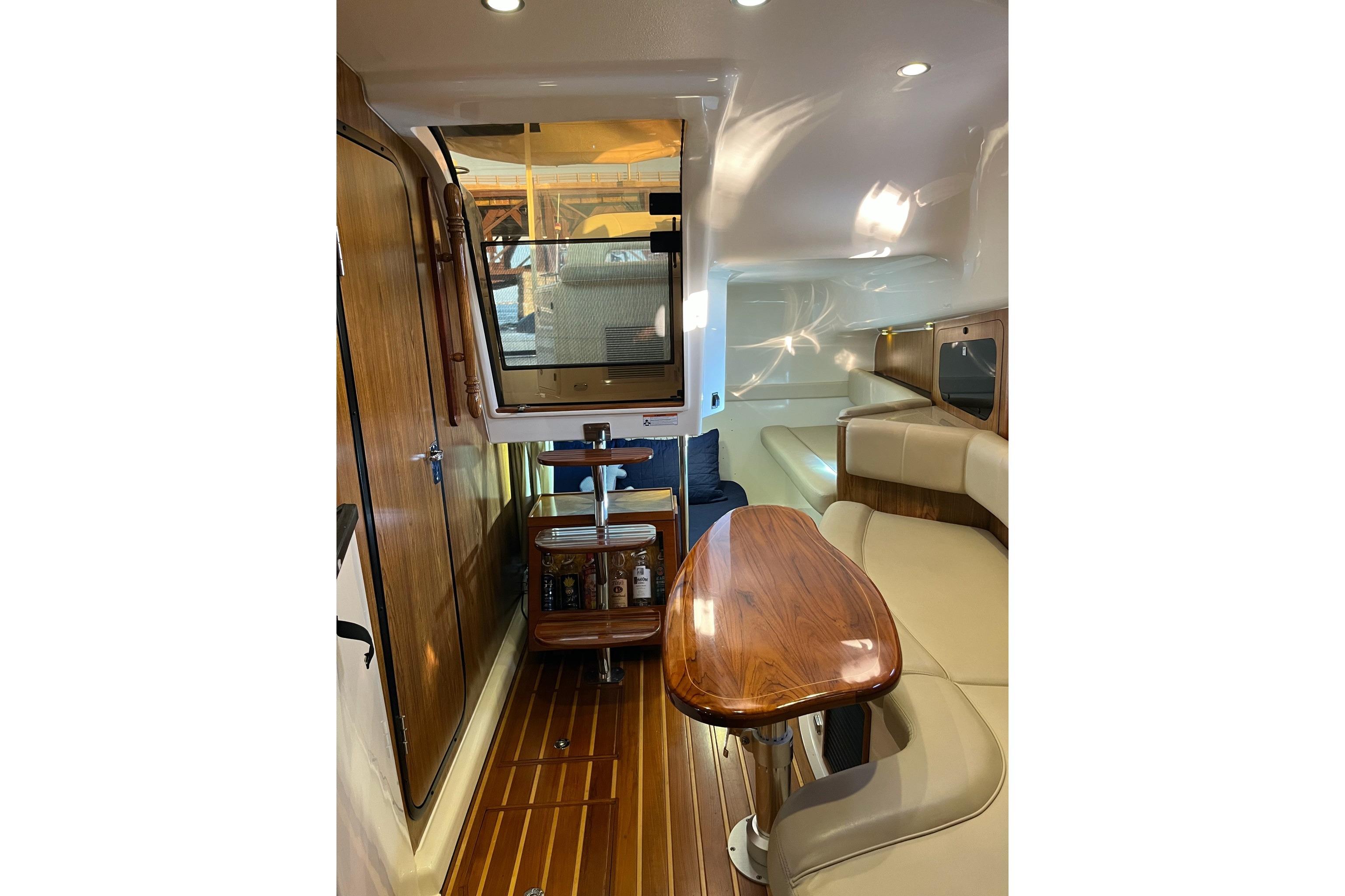 Interior of 2009 Pursuit OS 375 Offshore boat with wood accents and seating area.