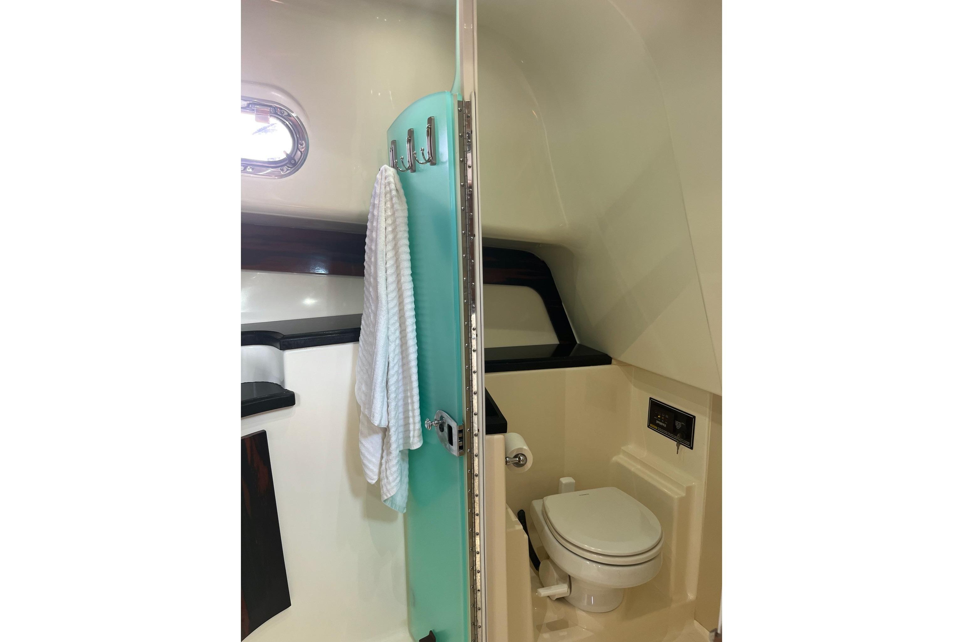 2009 Pursuit OS 375 Offshore boat bathroom with toilet and towel rack.