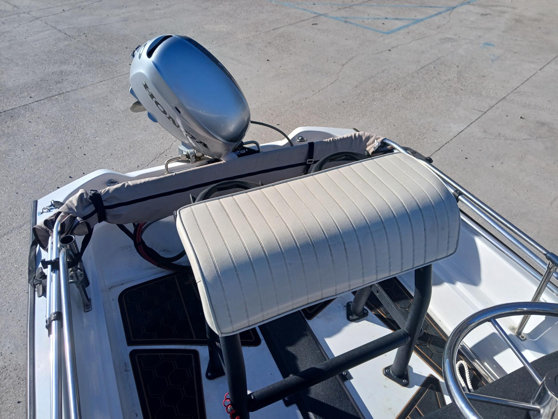 1980 Boston Whaler 15 Montauk boat interior with motor and seating.