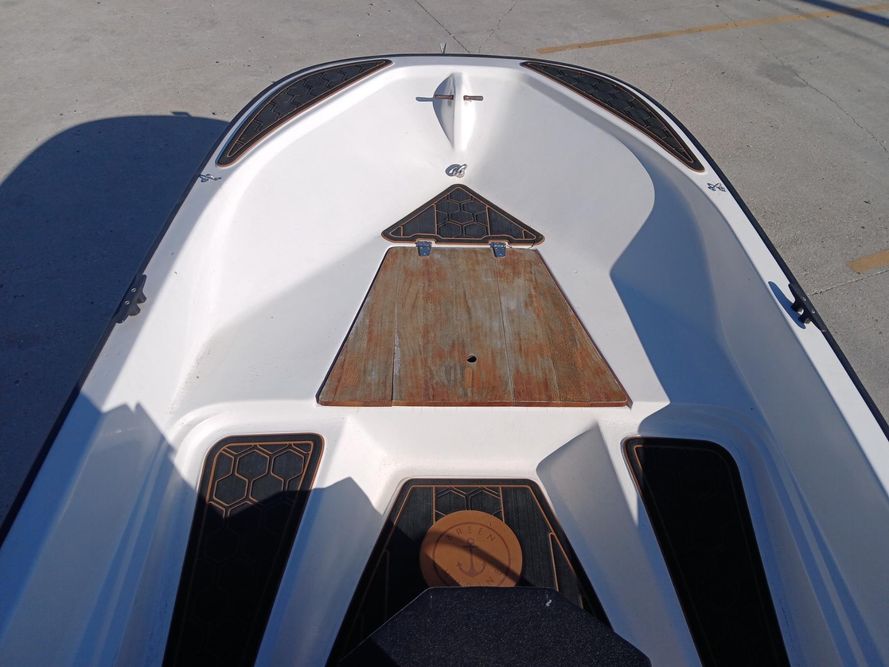 1980 Boston Whaler 15 Montauk boat interior with wooden deck and black accents.