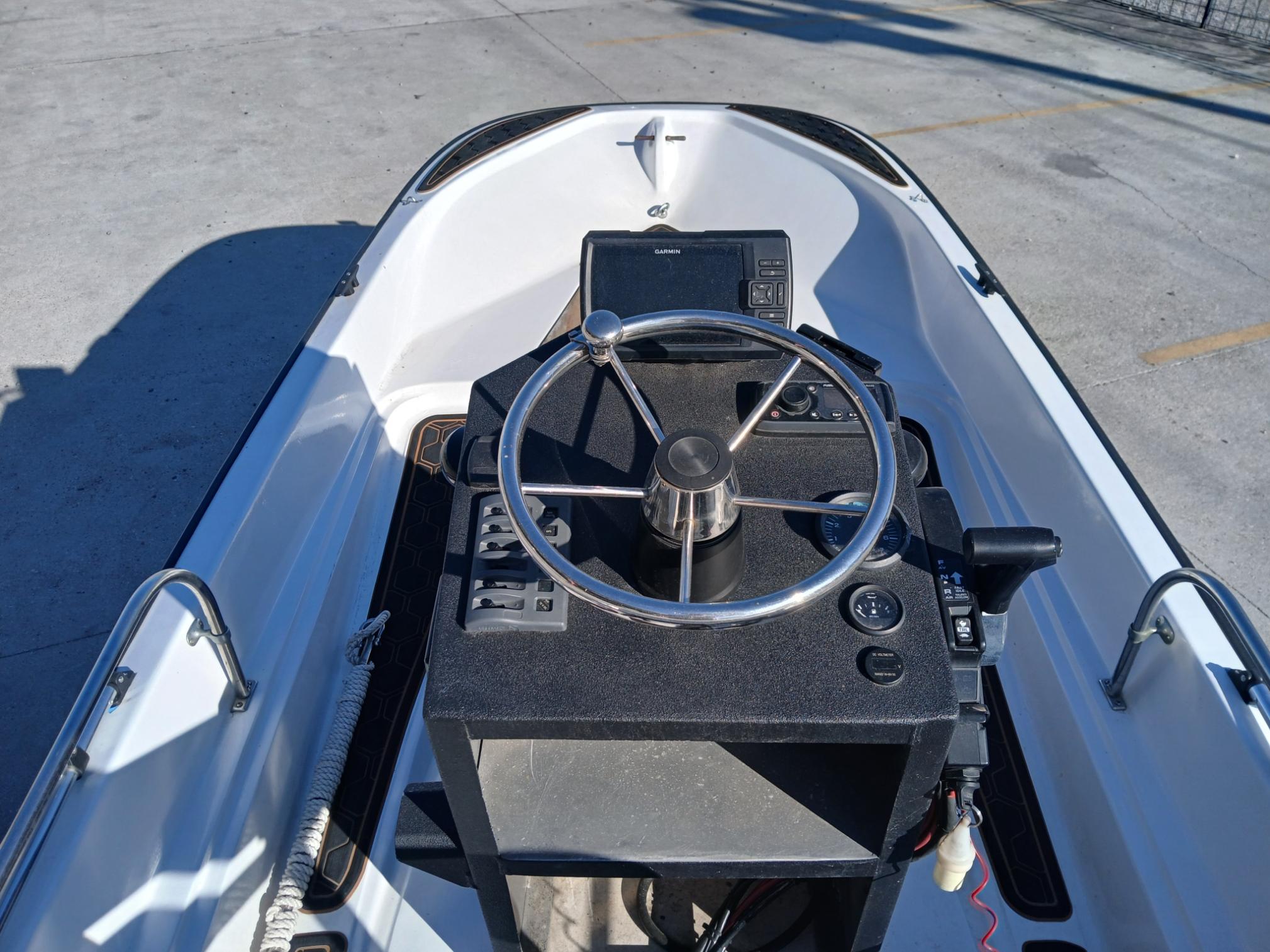1980 Boston Whaler 15 Montauk boat interior with steering wheel and control panel.