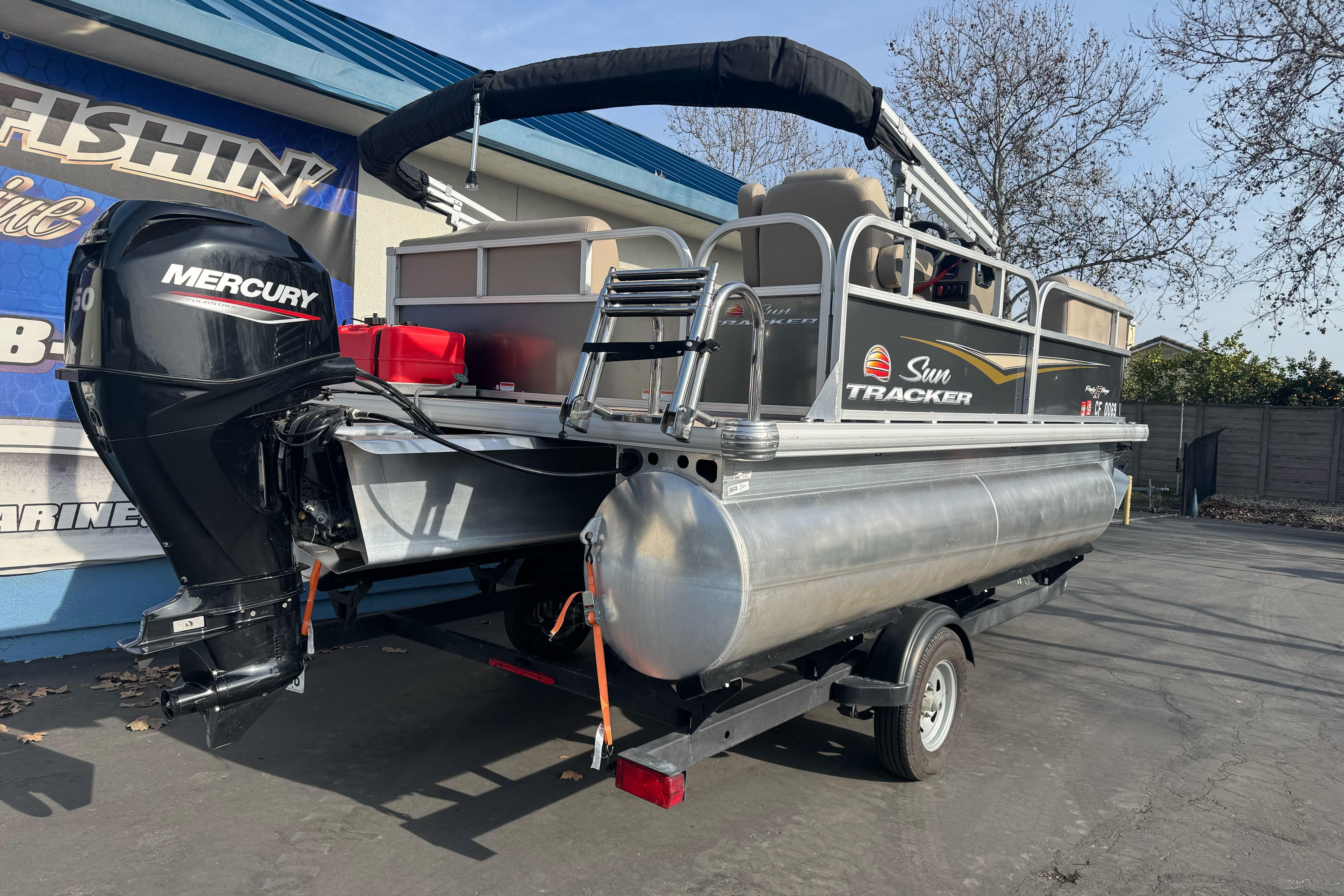 2024 Sun Tracker Party Barge 16 DLX pontoon boat with Mercury engine on trailer.