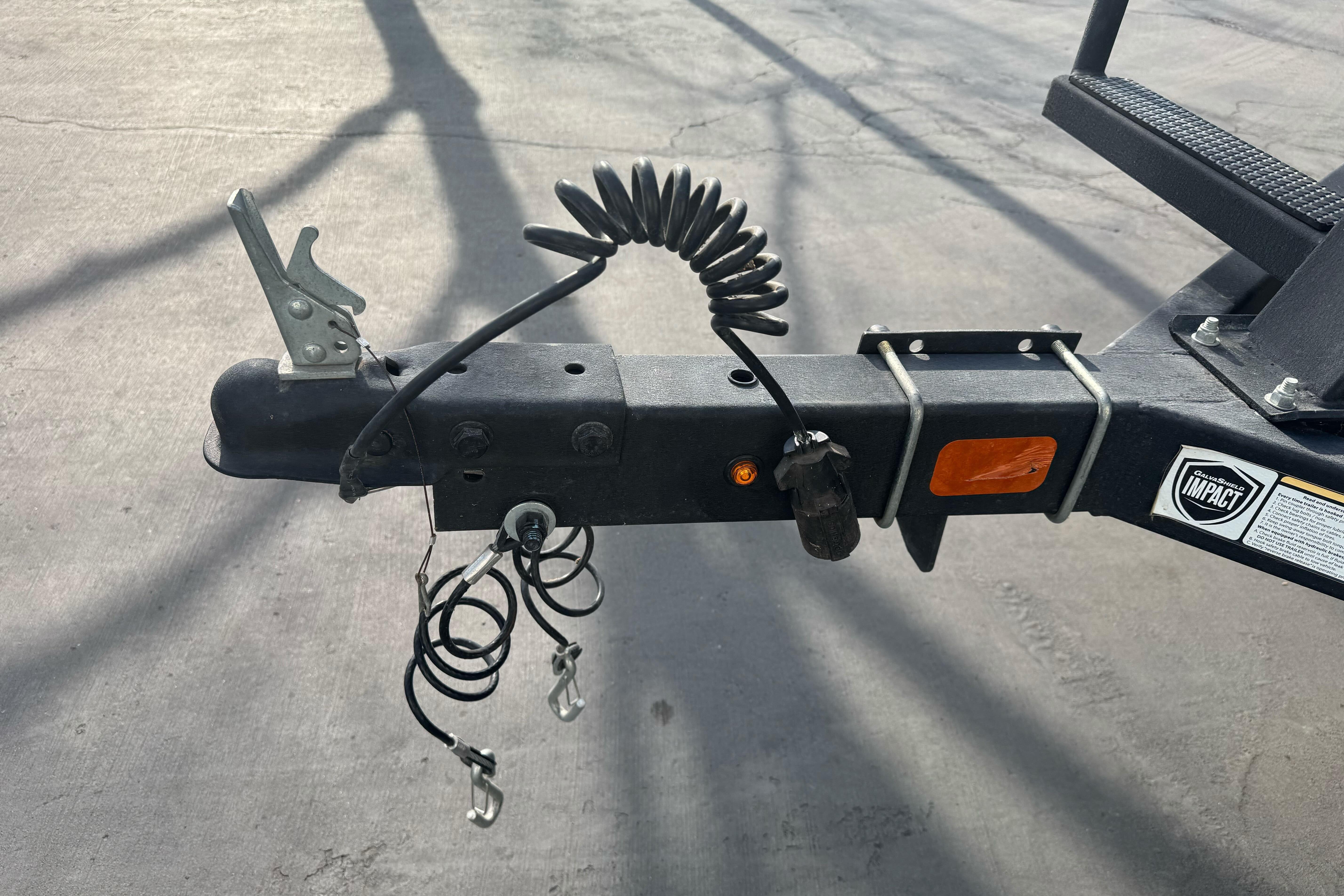 Trailer hitch of 2024 Sun Tracker Party Barge 16 DLX on concrete surface.