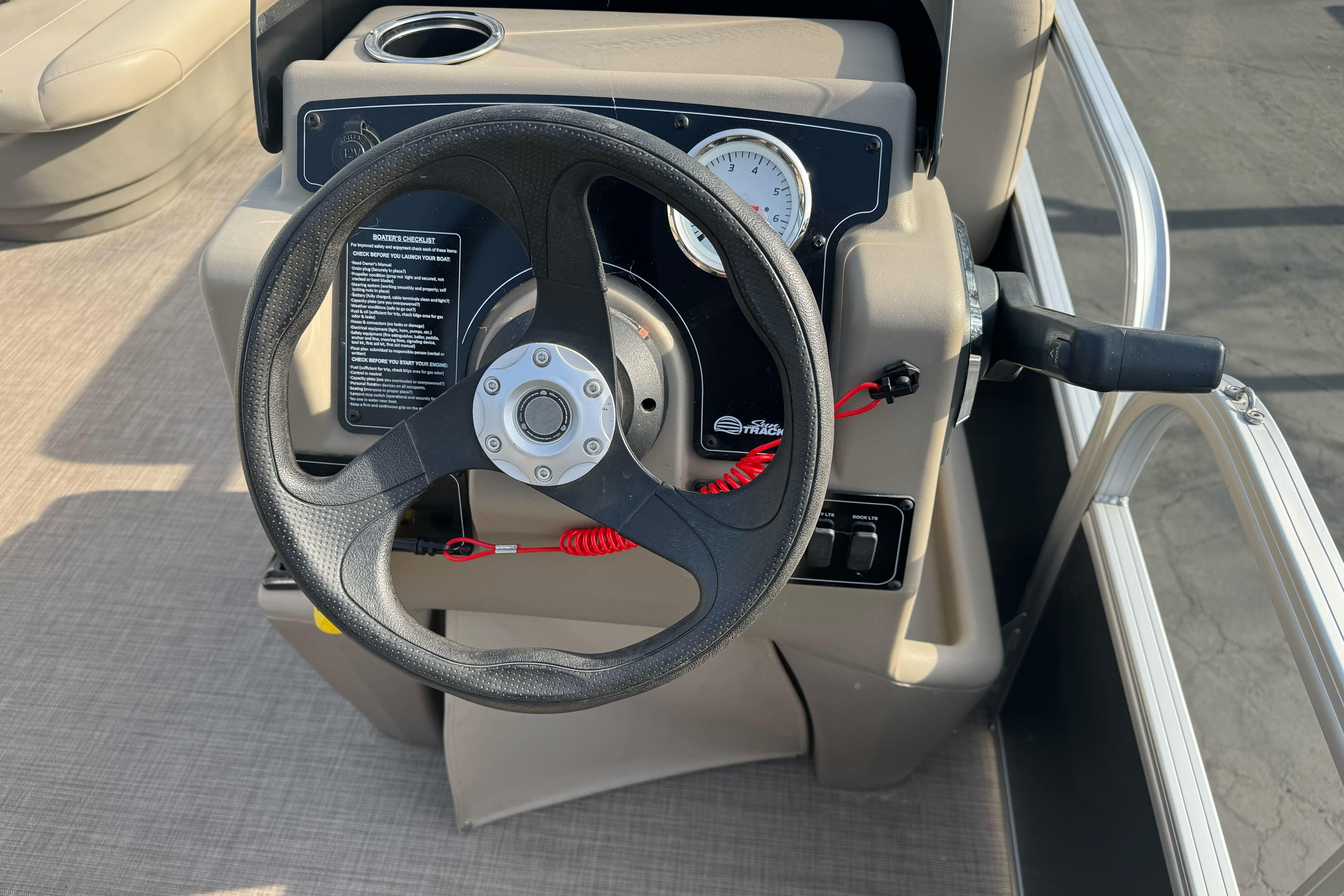 Steering console of 2024 Sun Tracker Party Barge 16 DLX pontoon boat.