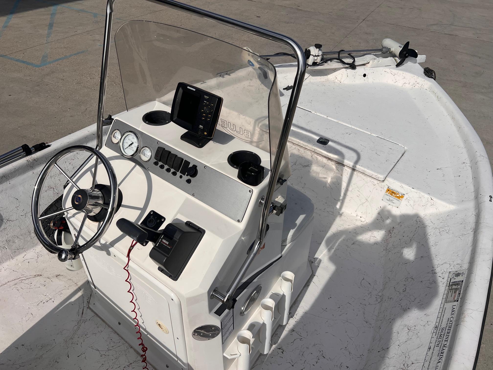 2010 Blue Wave 160 V Bay boat interior with steering wheel and control panel.