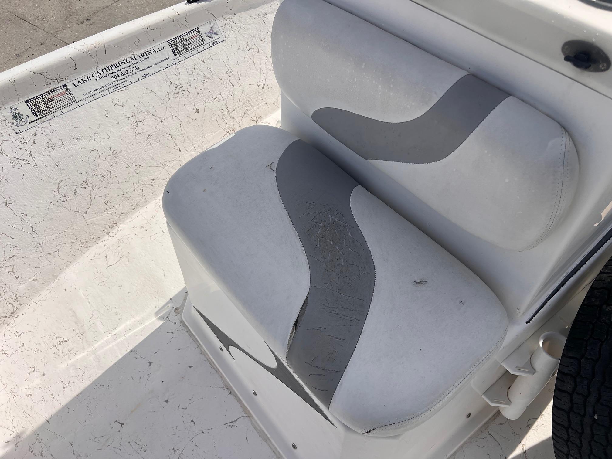 White and gray boat seat in a 2010 Blue Wave 160 V Bay.