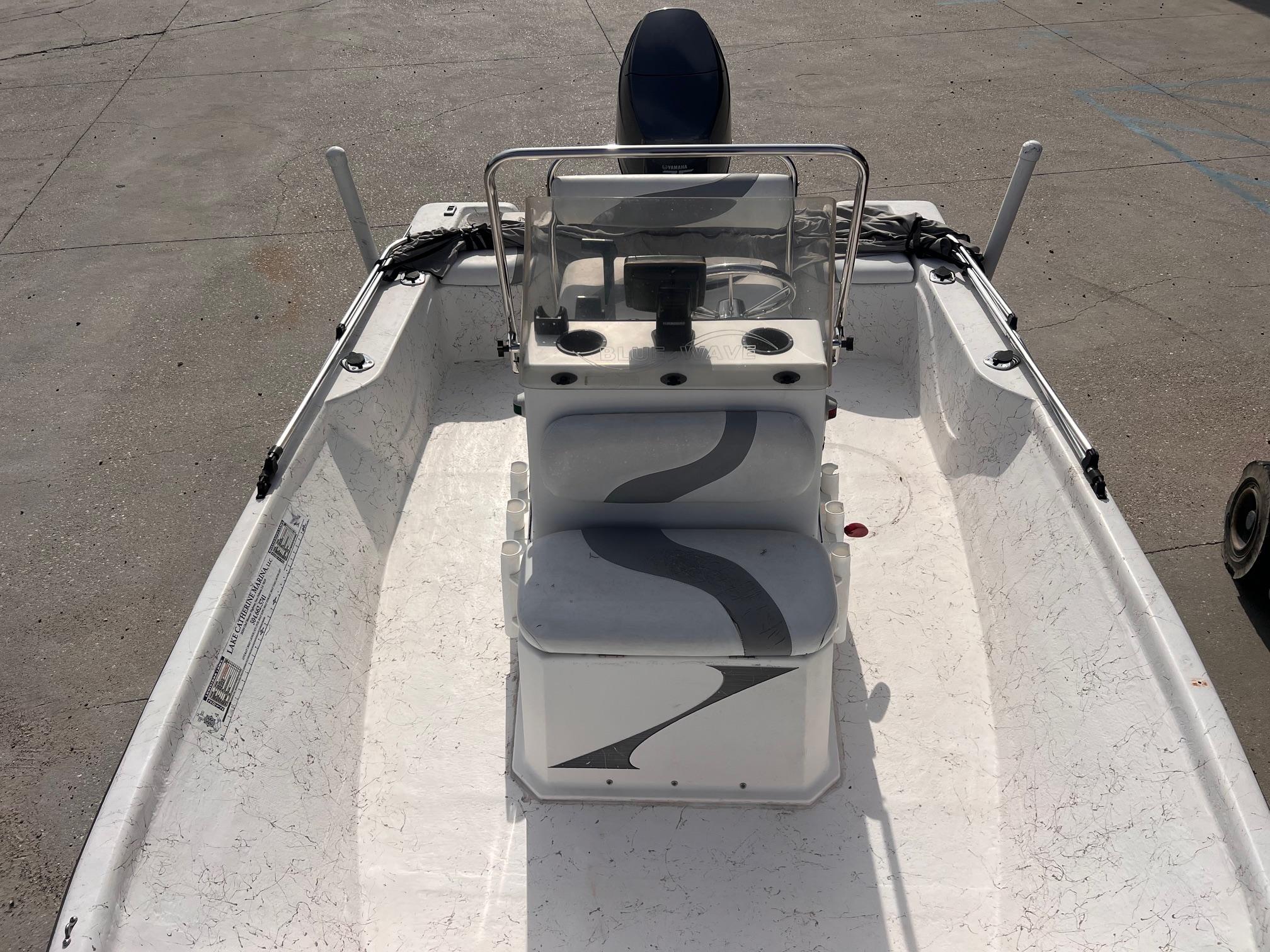 2010 Blue Wave 160 V Bay boat interior with steering console and seating.