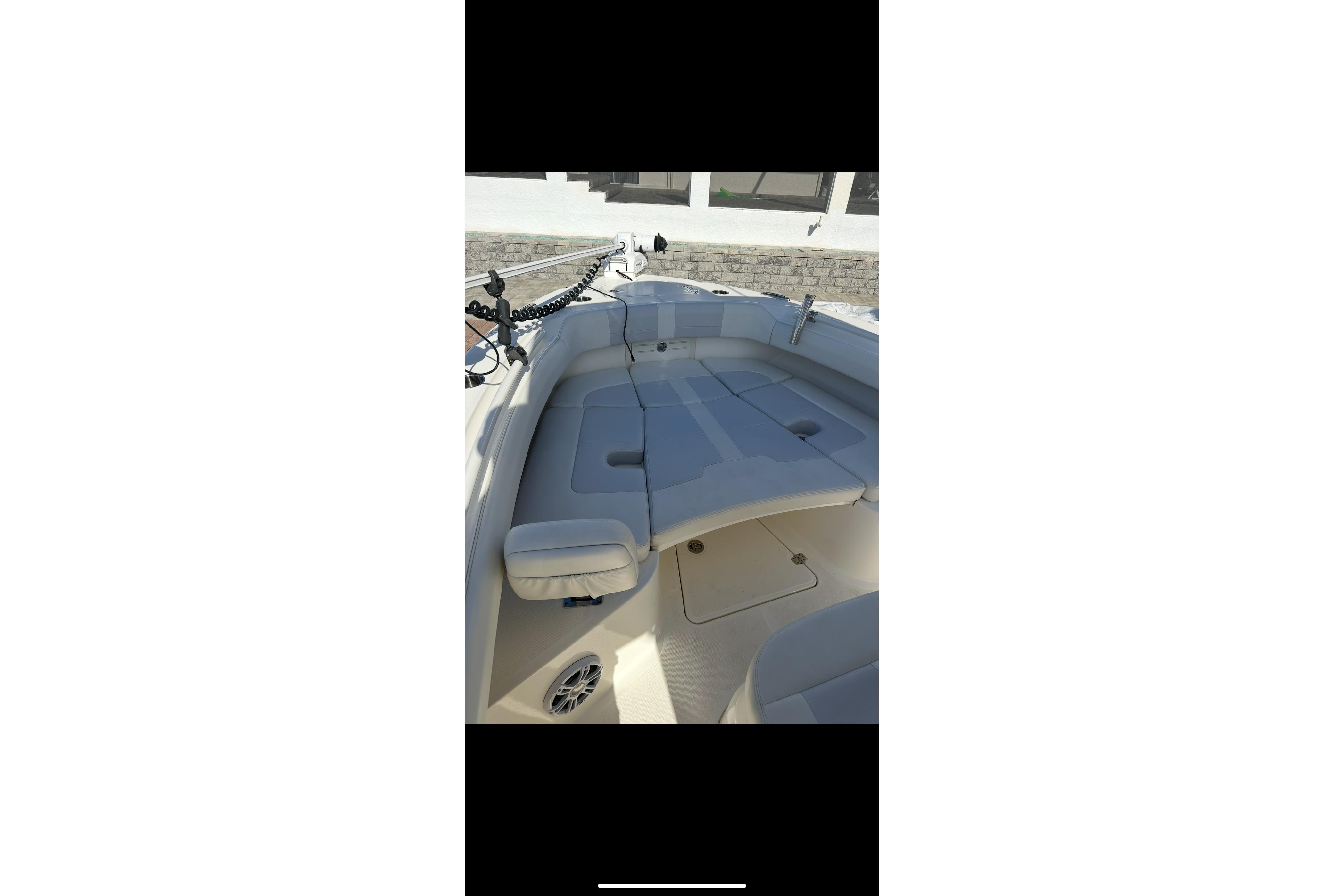 2020 Mako 235 boat interior with cushioned seating and storage compartments.