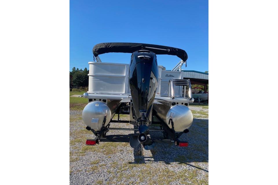 2026 Sun Tracker Party Barge 18 DLX pontoon boat, rear view with motor, outdoors.