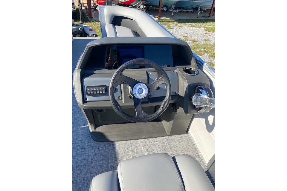 2026 Sun Tracker Party Barge 18 DLX steering console with modern controls and seating.