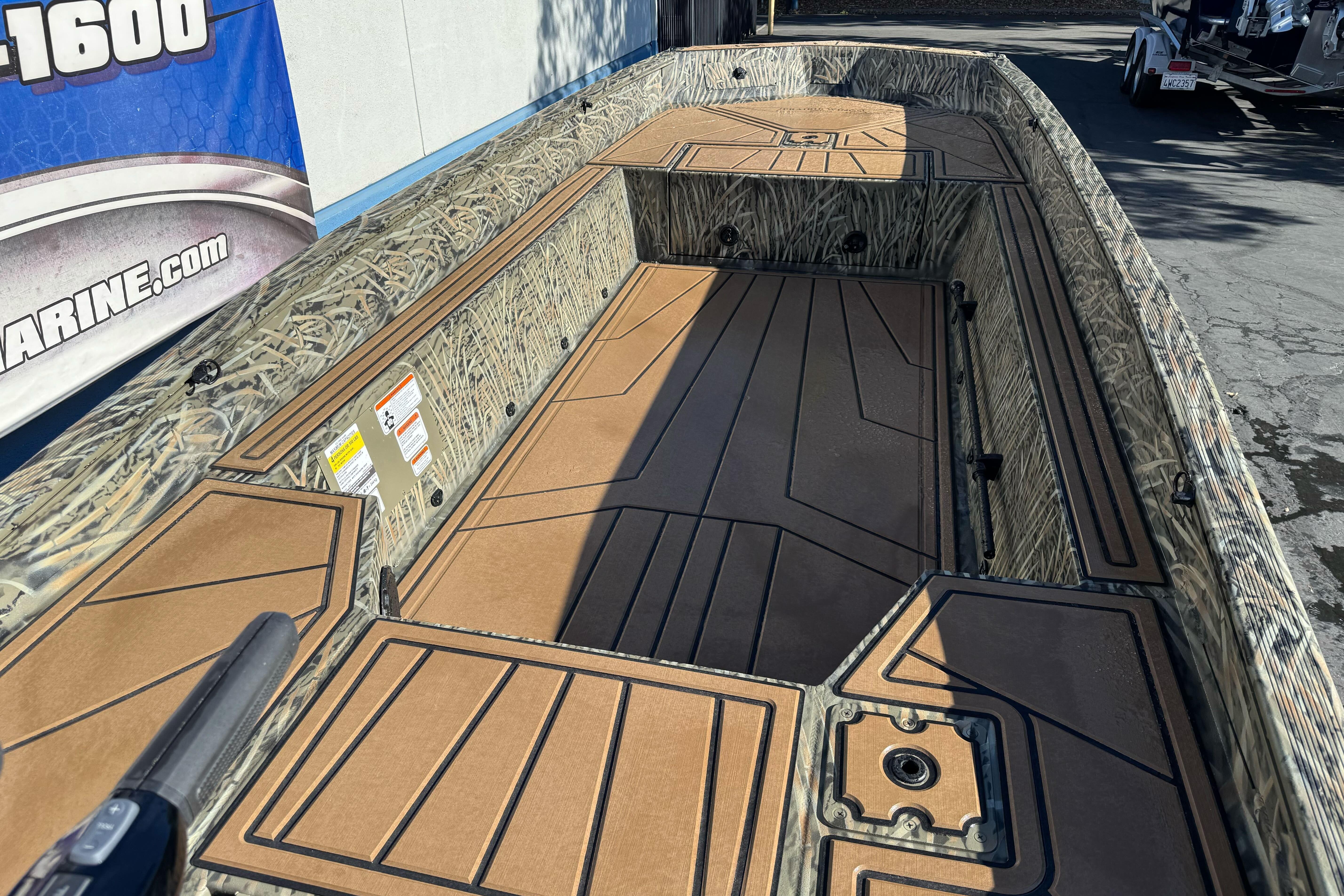 2026 Tracker Grizzly 1650 T Prairie Wings Edition boat interior with camo design and spacious deck.