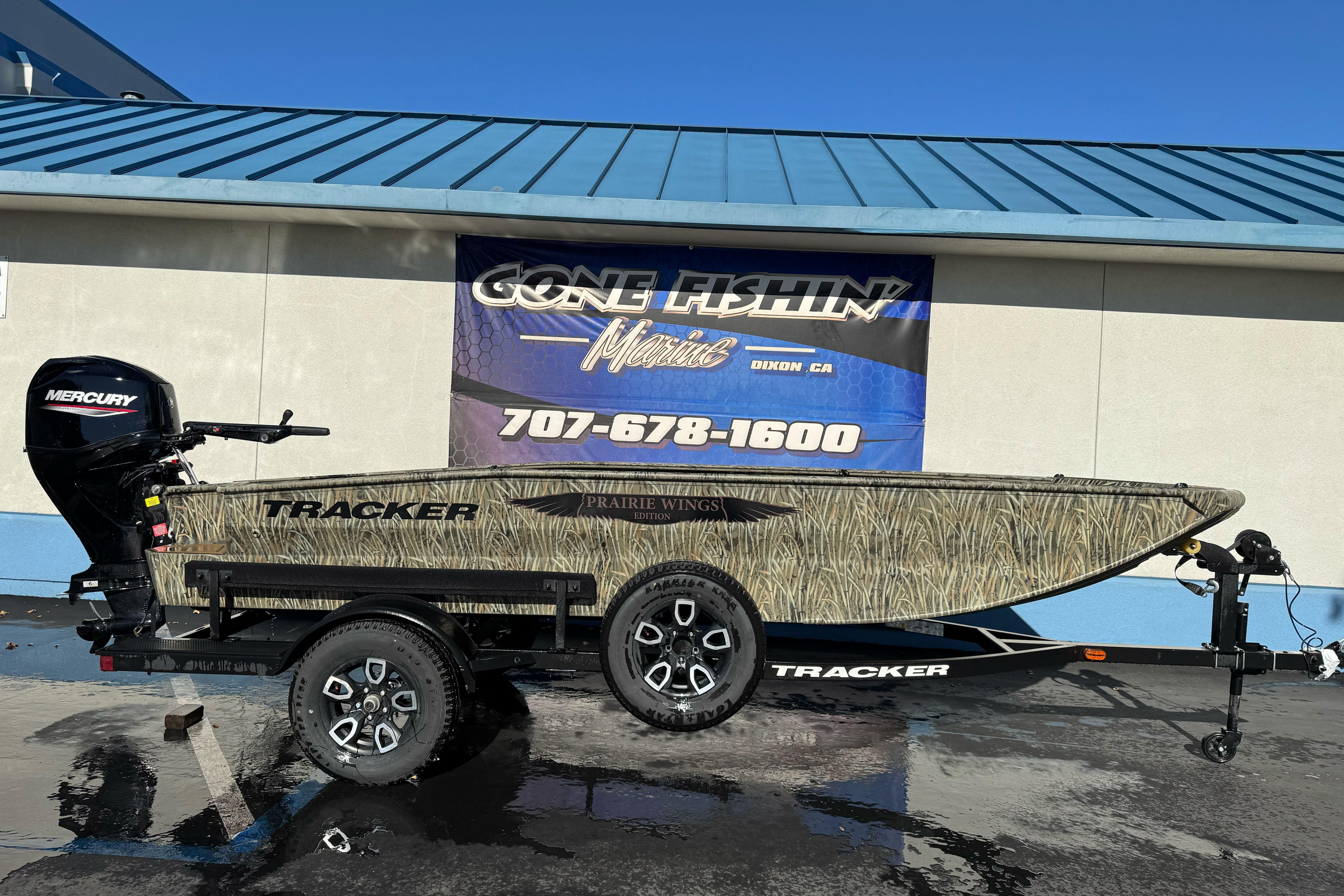 2026 Tracker Grizzly 1650 T Prairie Wings Edition boat on trailer, displayed outdoors.