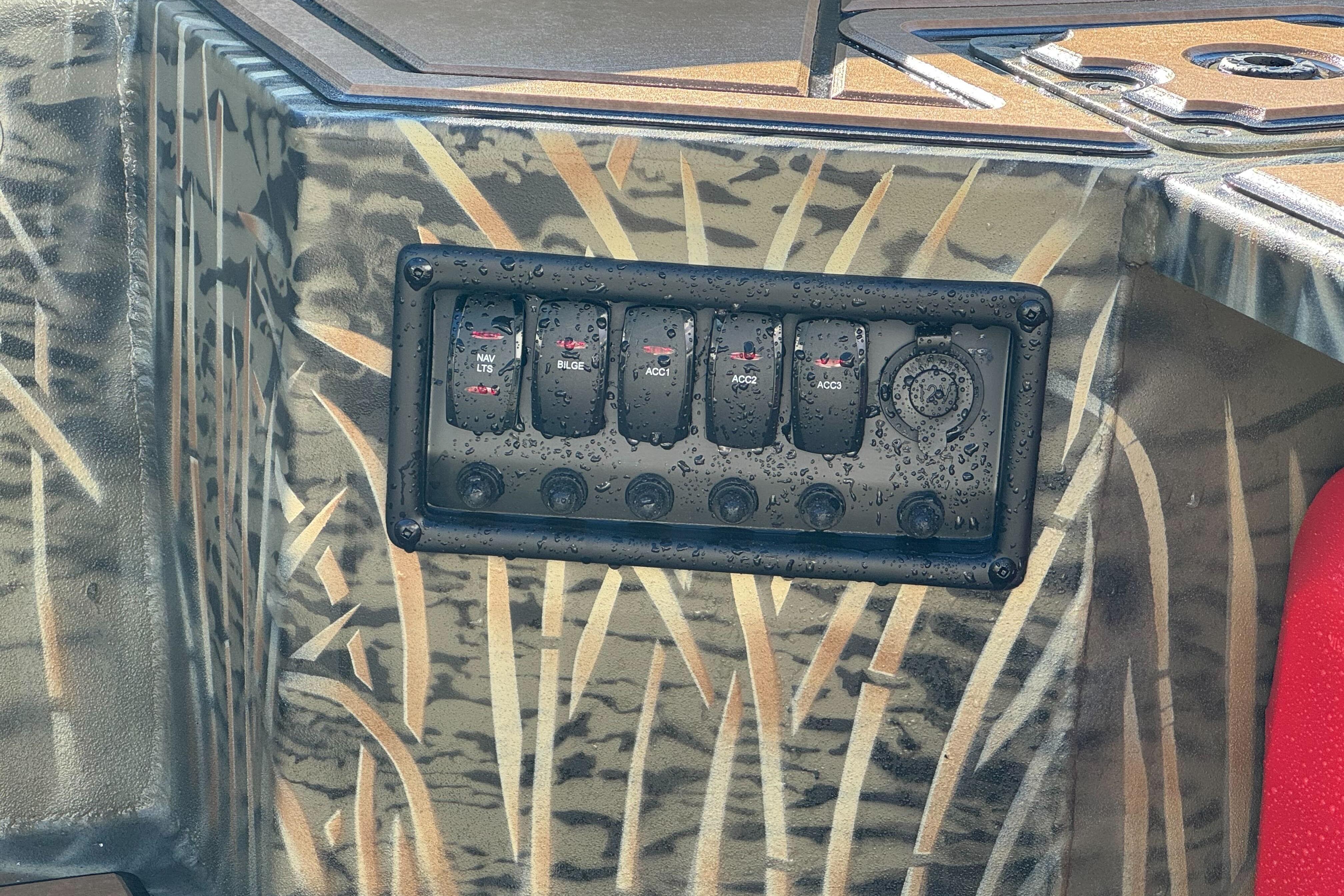 Control panel on 2026 Tracker Grizzly 1650 T Prairie Wings Edition, featuring camo design and switches.