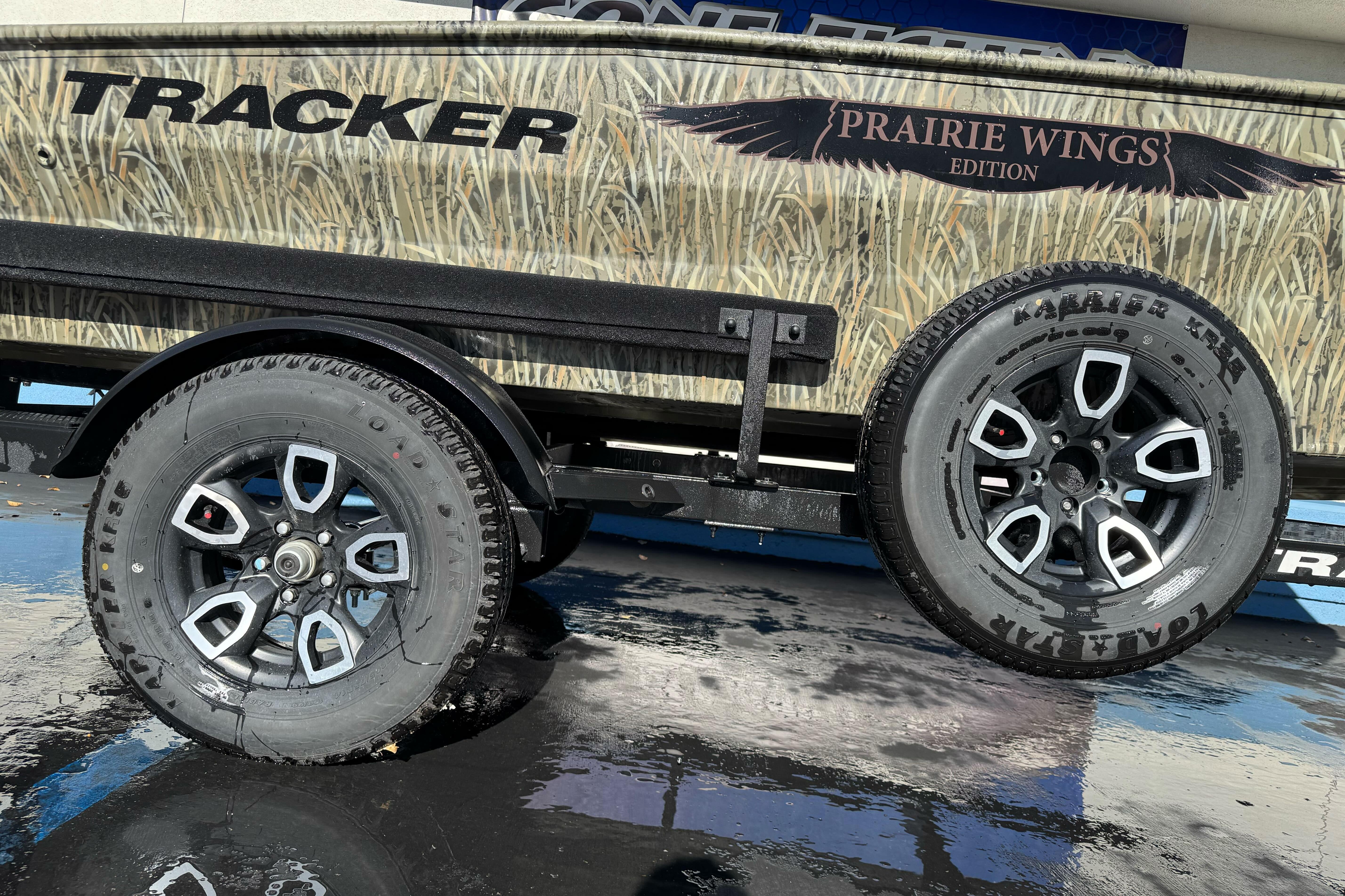 2026 Tracker Grizzly 1650 T Prairie Wings Edition trailer with stylish wheels.