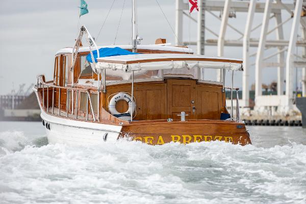 1939 Stephens Brothers Bridgedeck Cruiser on water, rear view, named "Sea Breeze."